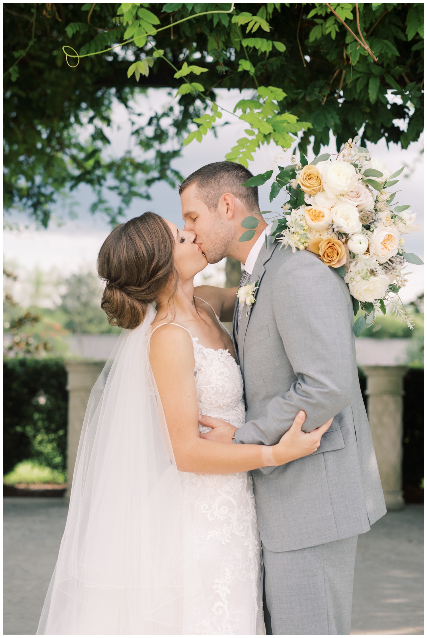 kissing bride and groom after wedding ceremony Houston