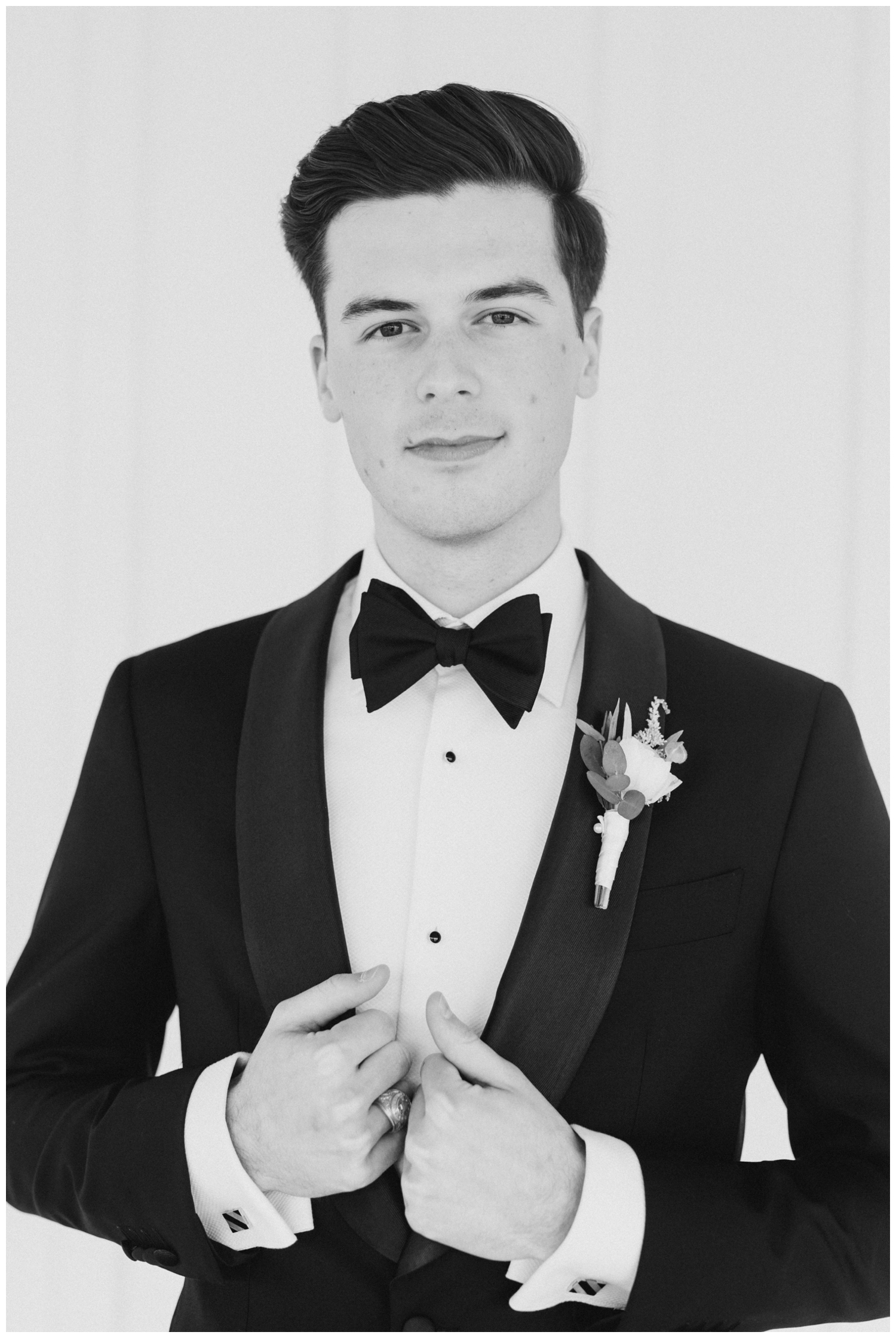 groom in black tux with black bow tie