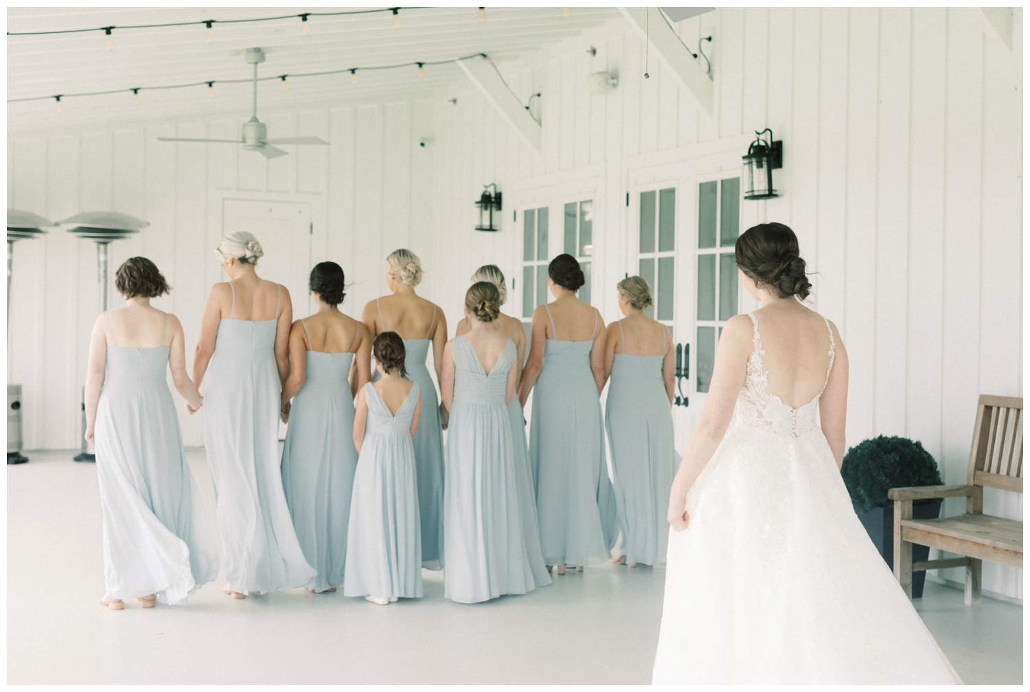 bride reveal to bridesmaids in light blue dresses at The Farmhouse in Montgomery, Texas