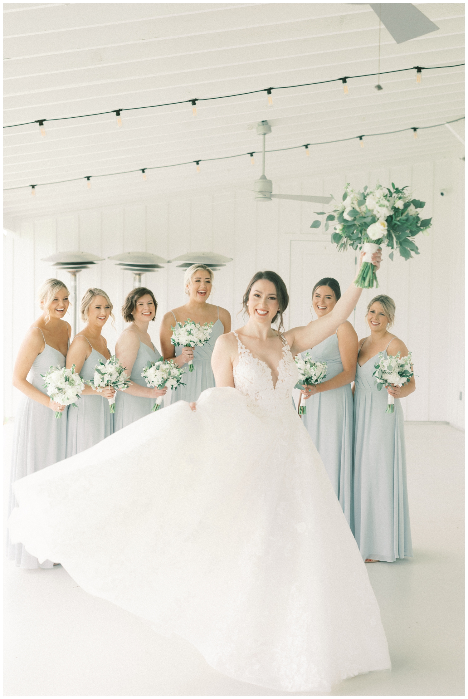 bride celebrating with bridesmaids for portraits outside in Montgomery Texas at The Farmhouse wedding