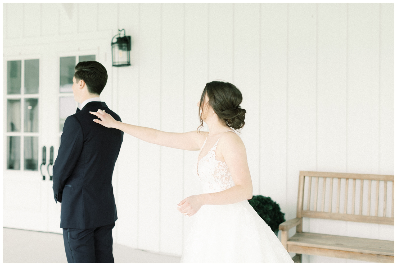 bride and groom first look on porch at The Farmhouse wedding venue