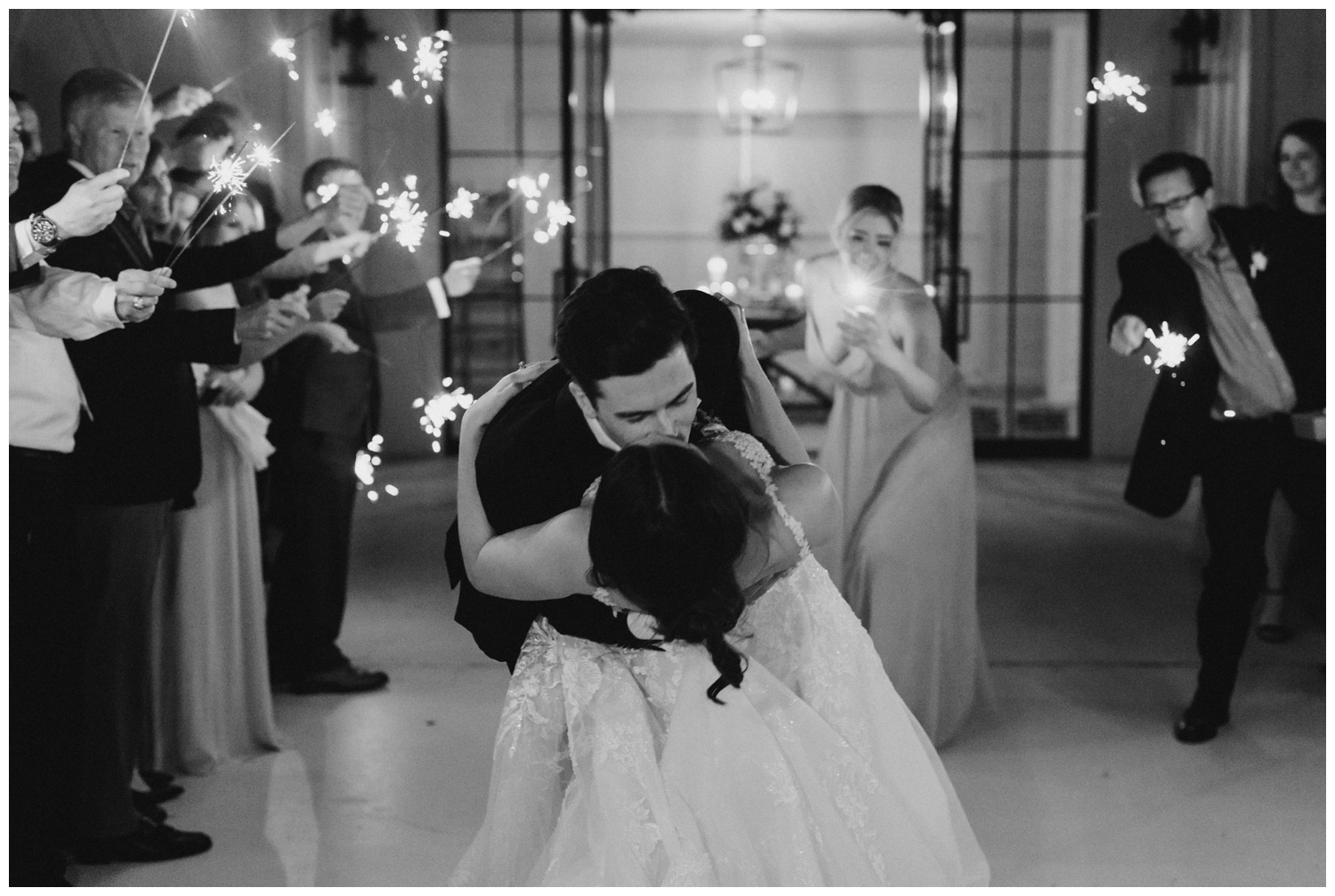 black and white photo of bride and groom sparkler exit