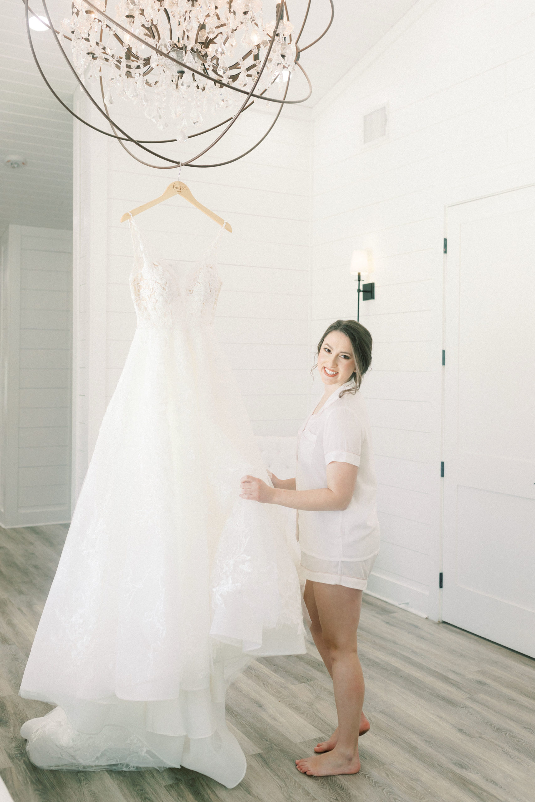 Bride with her dress on hanger