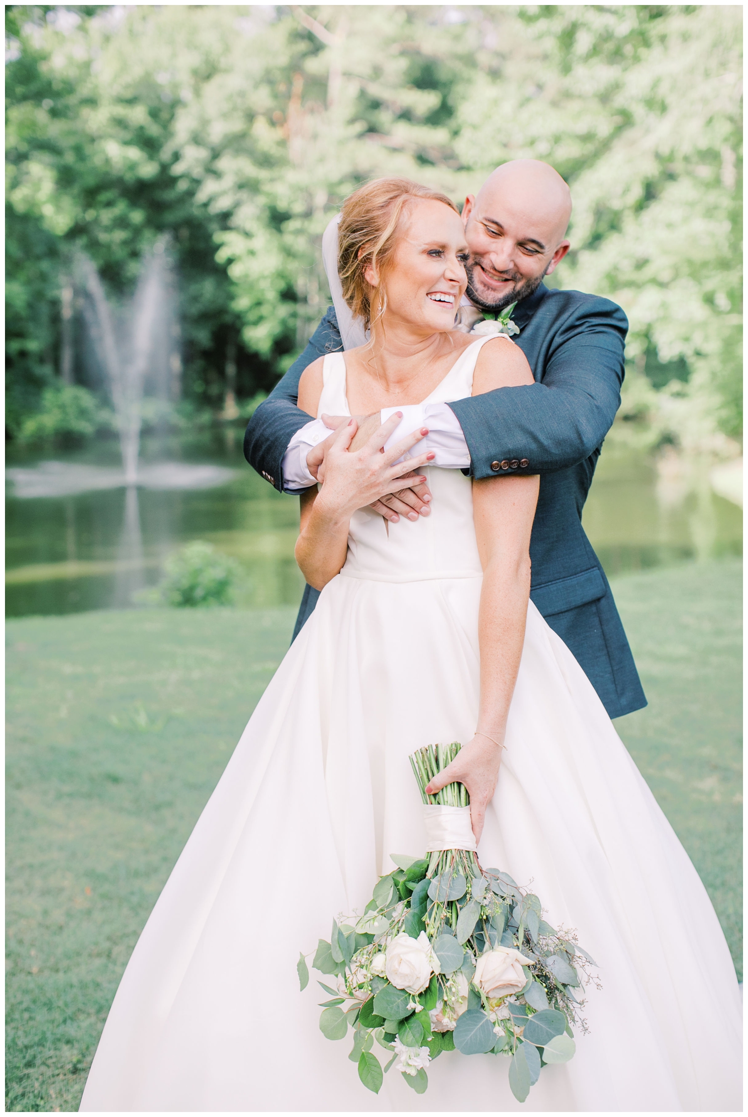 laughing-bride-and-groom-portrait-by-a-fountain