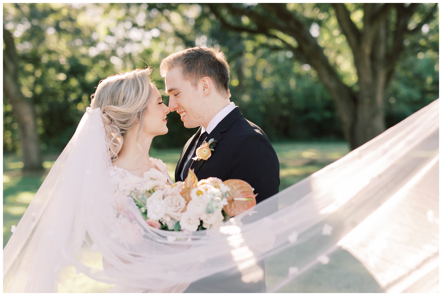 romantic veil shot of bride and groom outside oak tree at Addison Woods wedding venue Spring texas