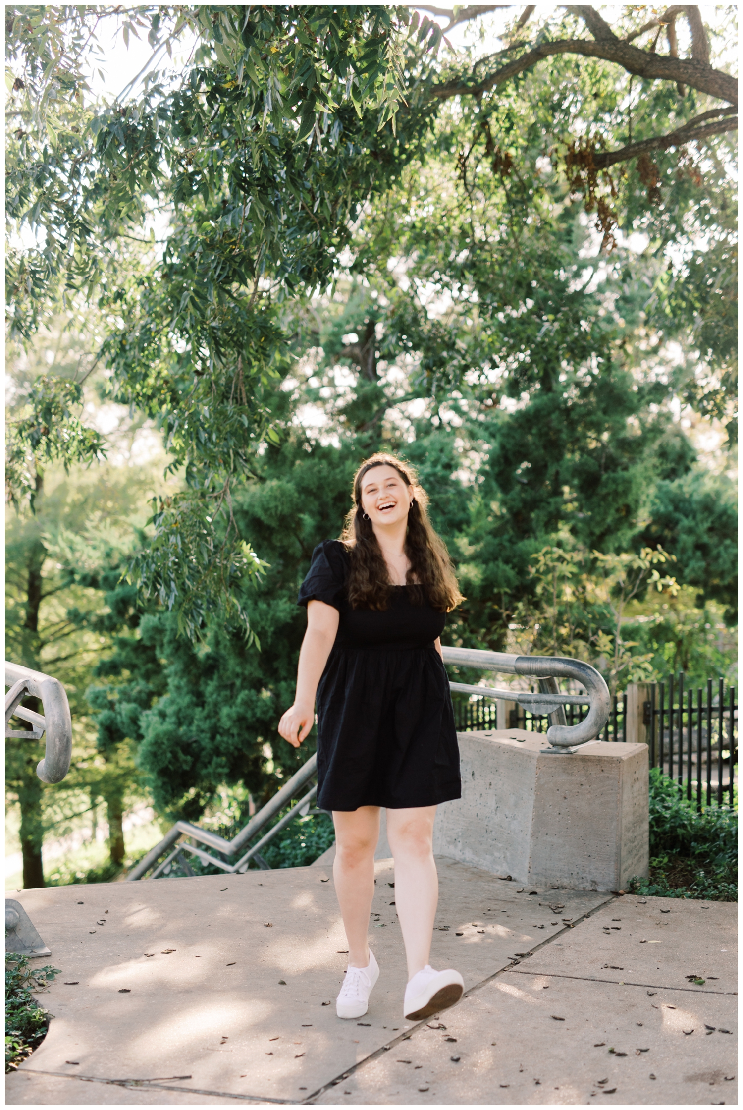 girl walking for senior portraits at Buffalo Bayou Park in Houston Texas with Reed Gallagher Photography