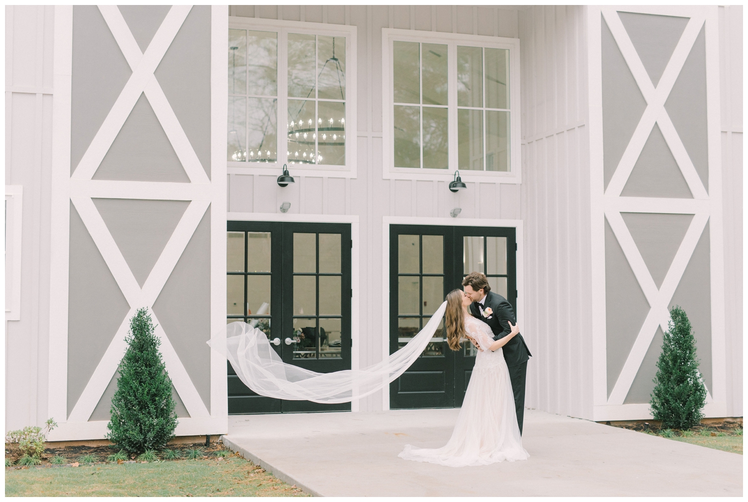 swooping shot of bride and groom kissing at wedding venue in Houston Texas