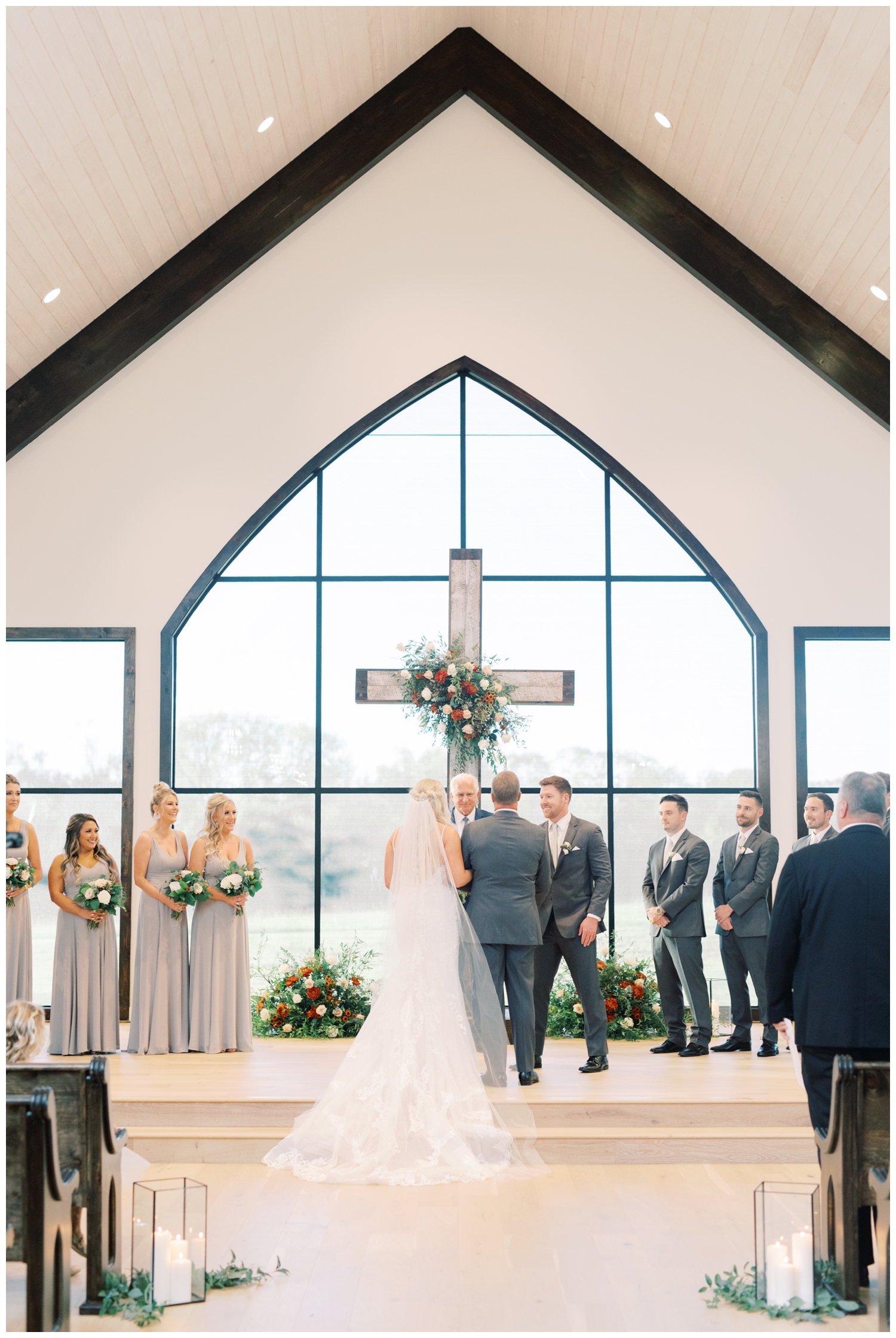 the chapel at Deep In The Heart Farms with bride and groom in front of the cross