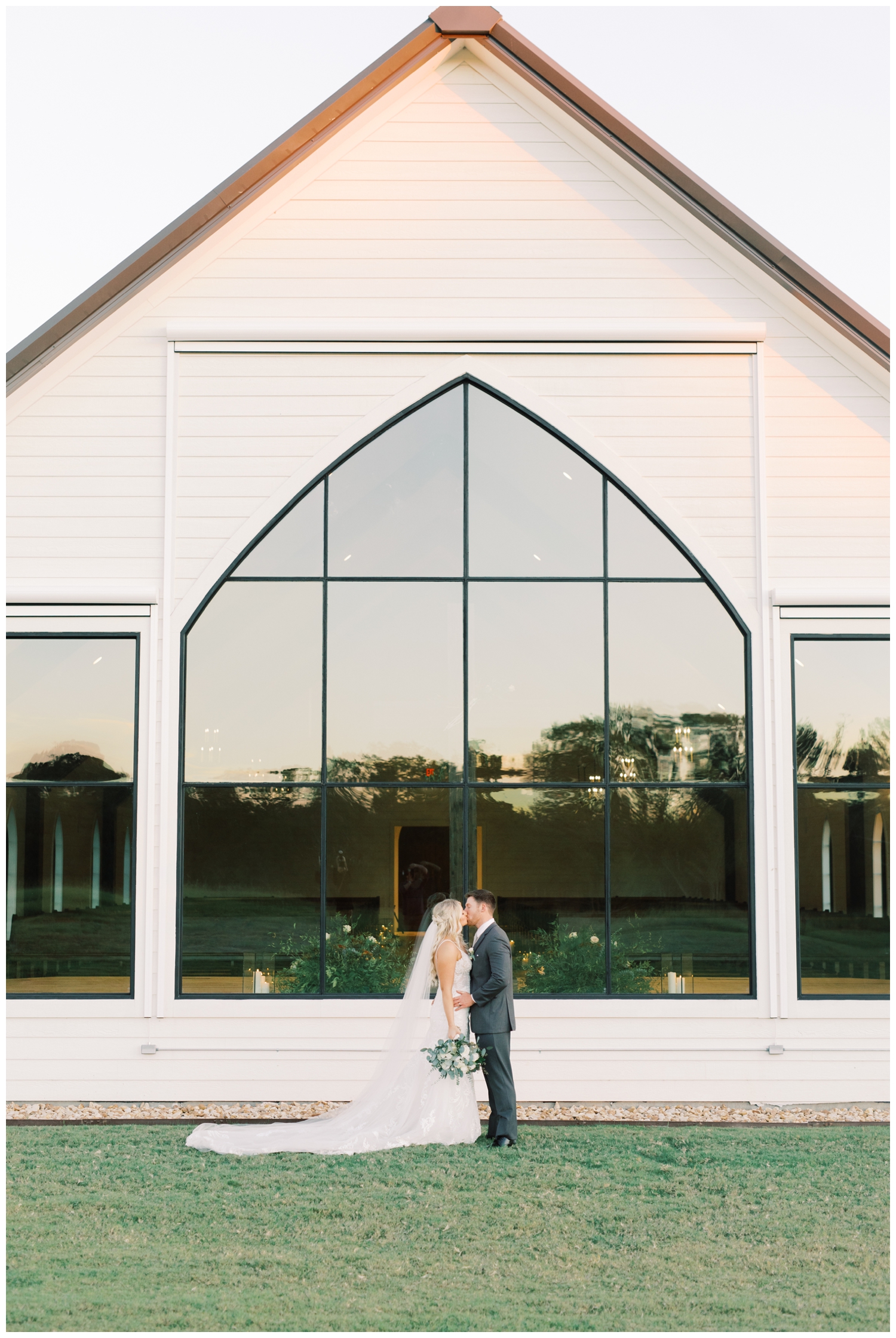 Deep In The Heart Farms window with bride and groom standing in front