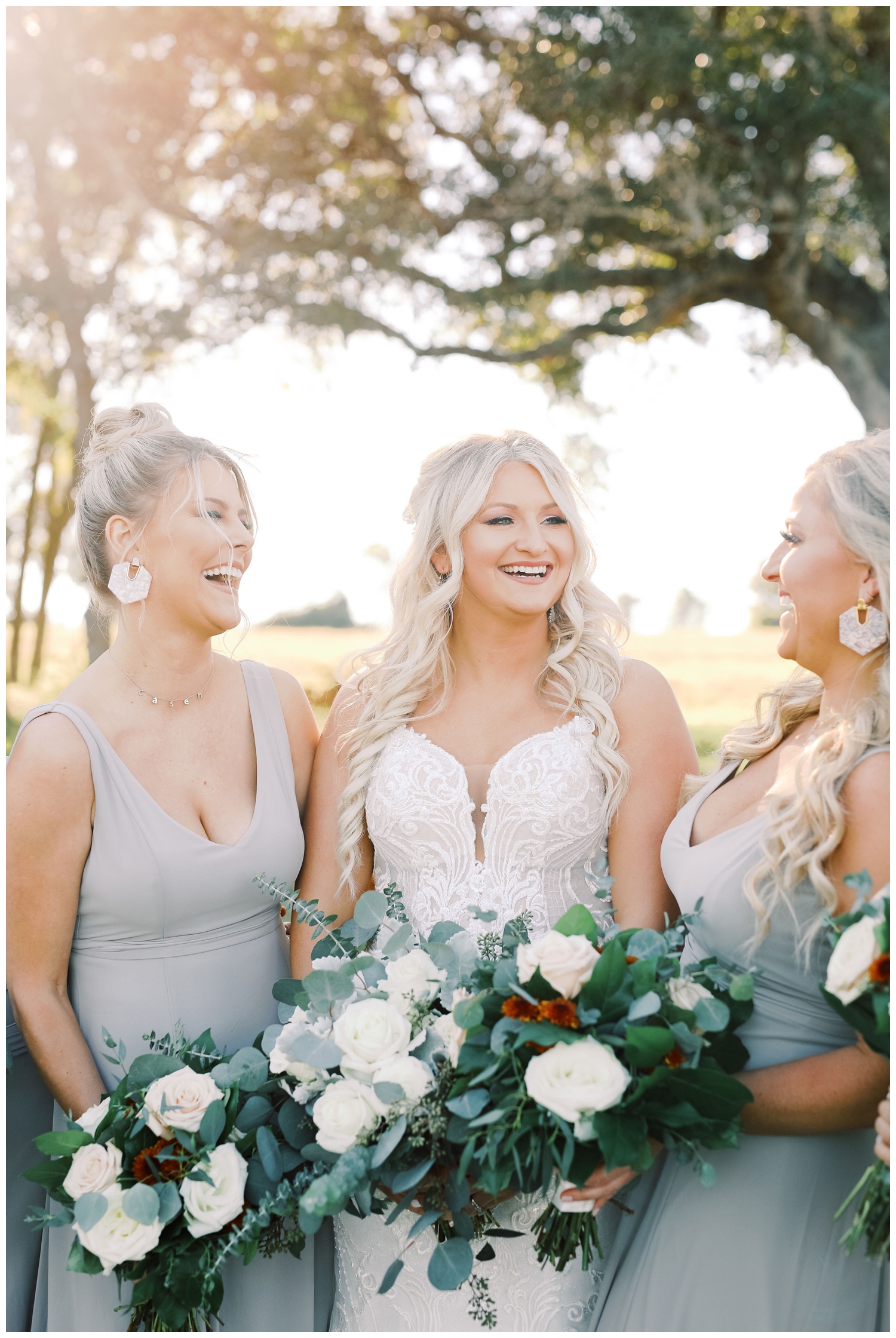 bride laughing with bridesmaids during sunset portraits