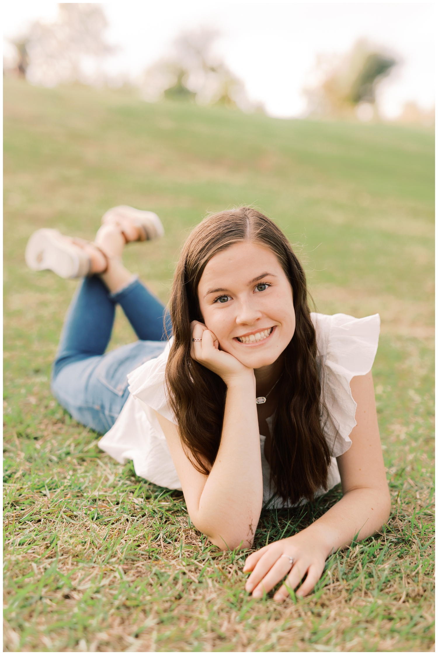 Houston senior session at Buffalo Bayou with a girl posing while laying on the ground