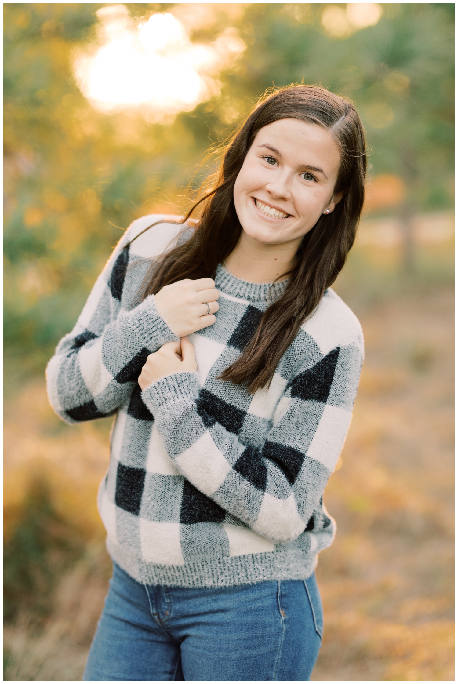 girl wearing a black and white plaid sweater during her Houston senior photography session