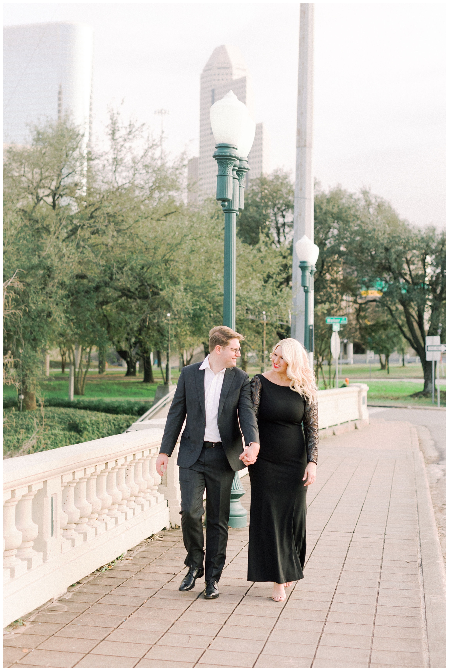 engaged couple walking on Sabine Bridge downtown Houston skyline
