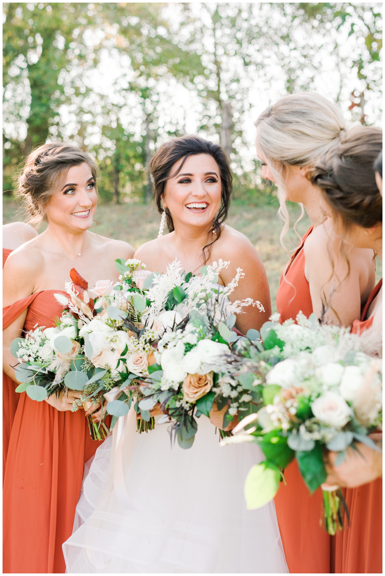 bride laughing with bridal party