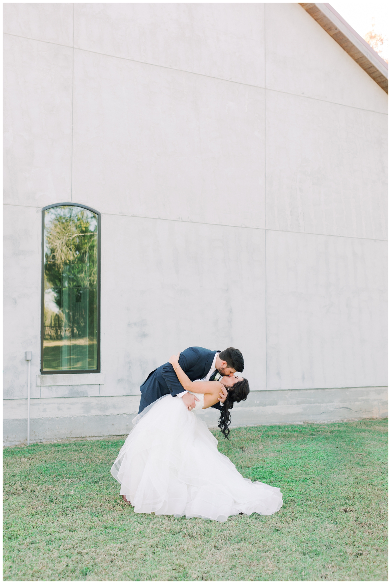 dip kiss in front of Montgomery wedding venue