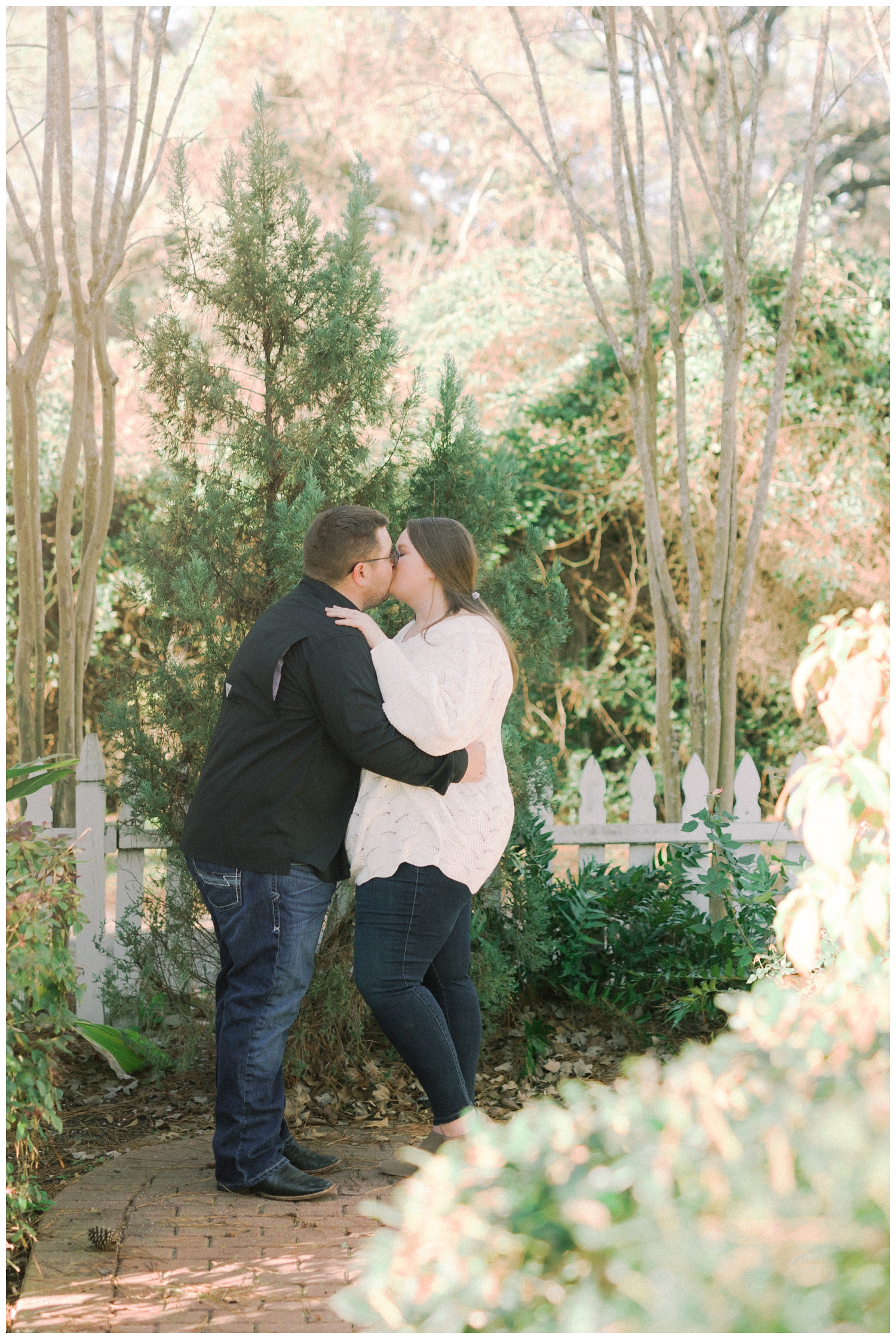 engaged couple kissing outside