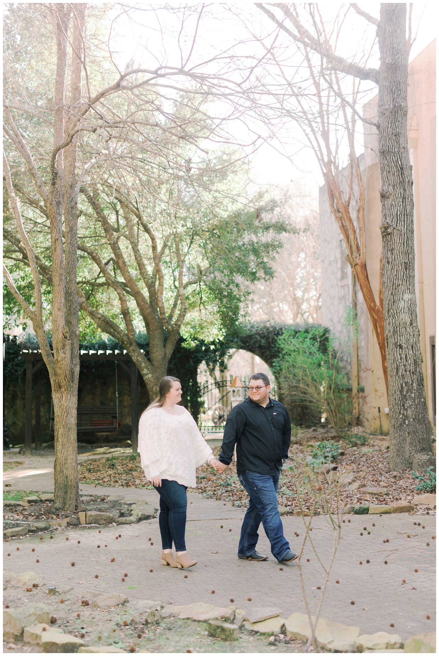 couple holding hands during engagement session in Cypress at Cy-Hope
