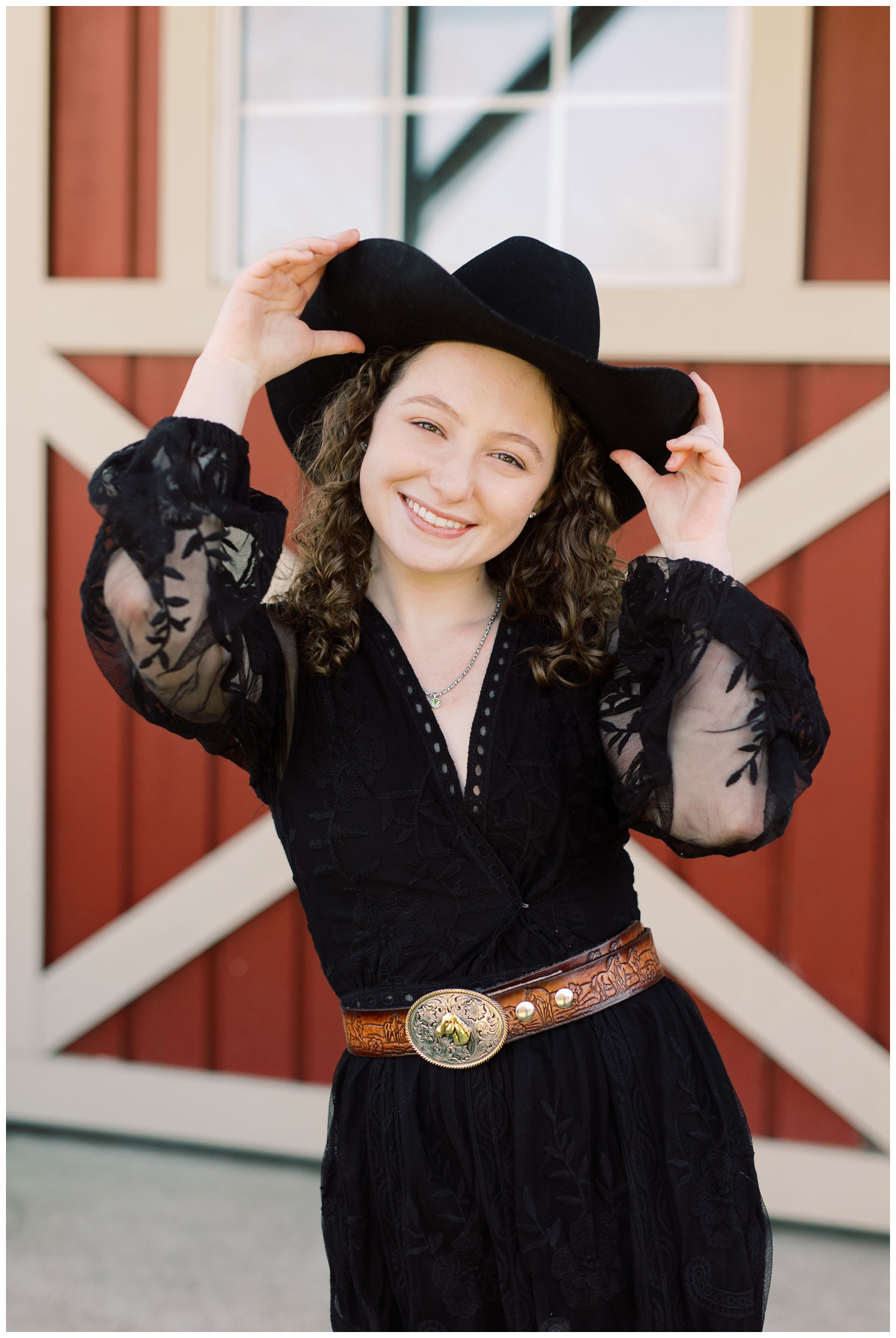high school girl in black dress tipping her cowboy hat at Havenly Farm