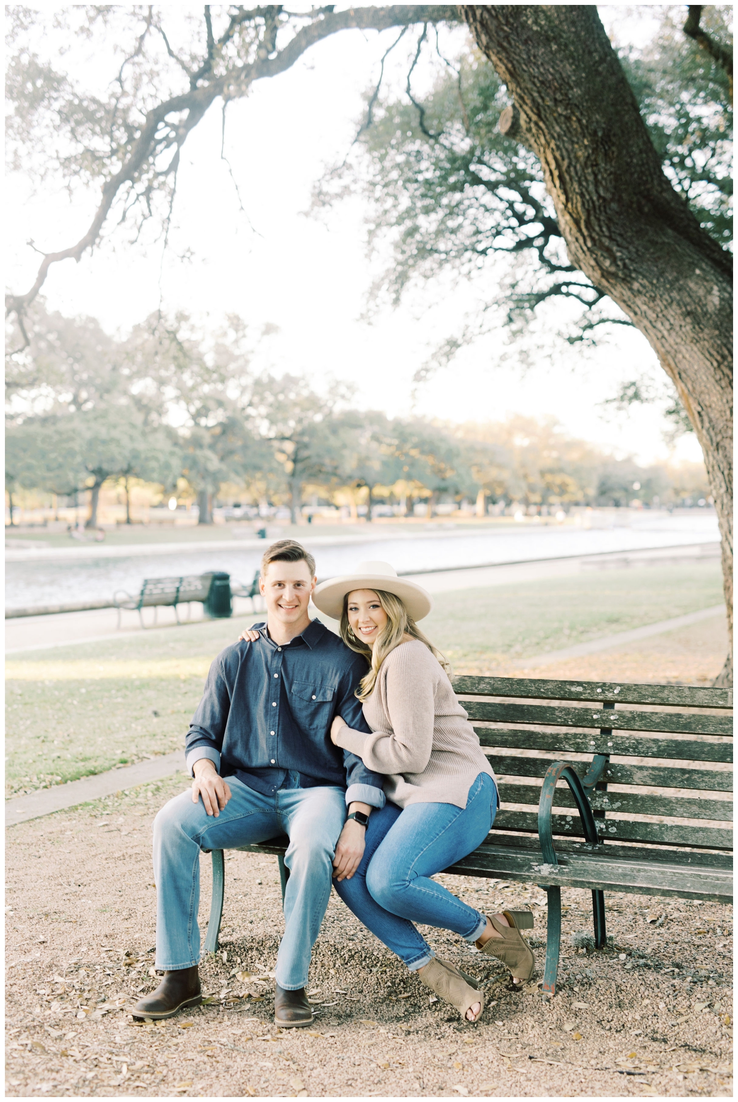 park bench at Hermann Park with engaged couple sitting
