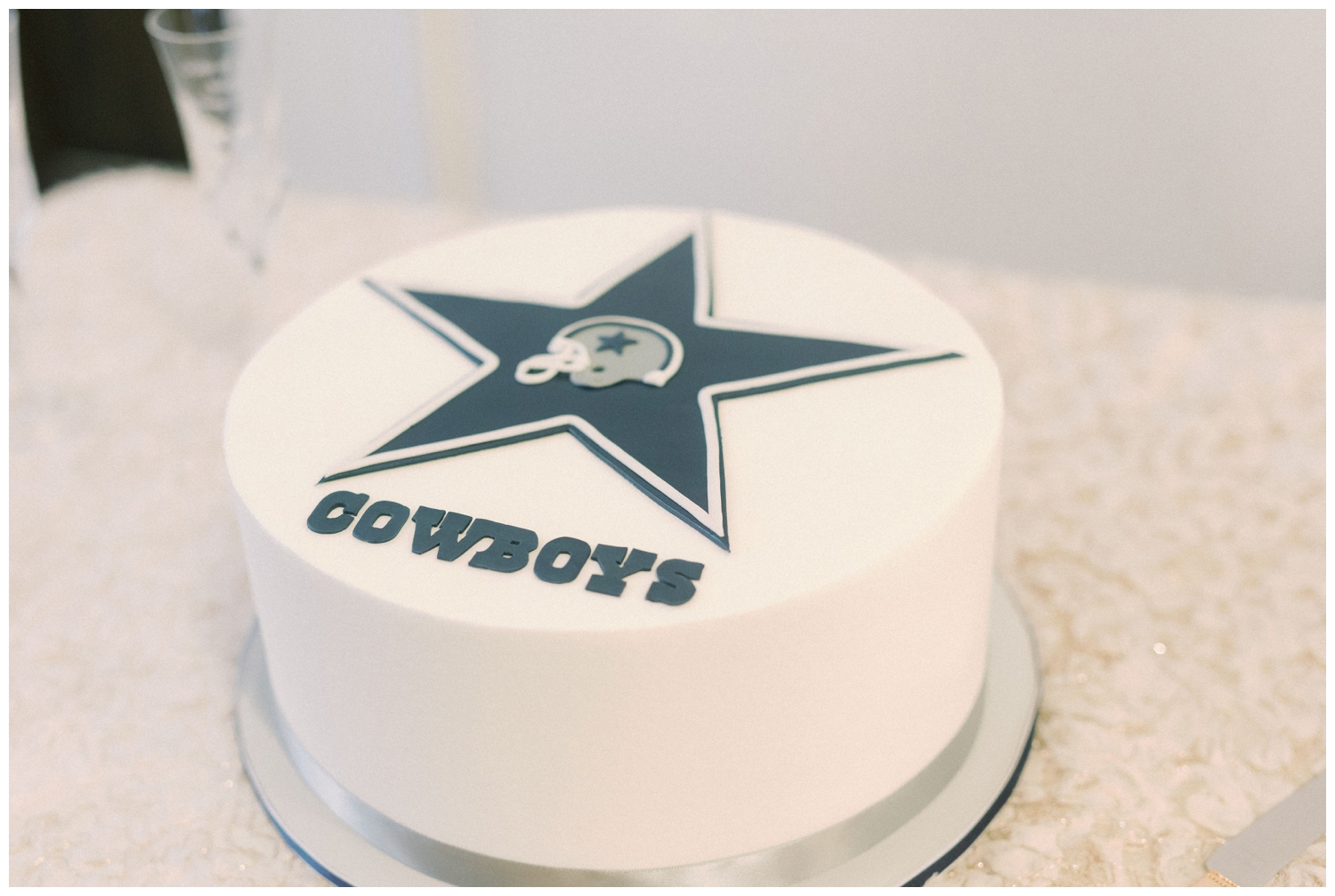 white Dallas Cowboy wedding cake