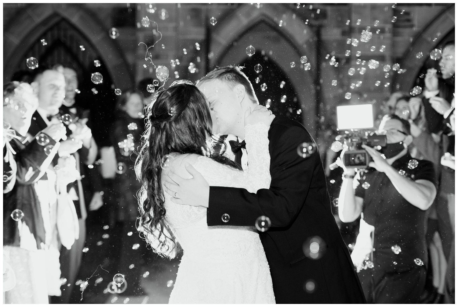 bride and groom kissing during a reception bubble exit