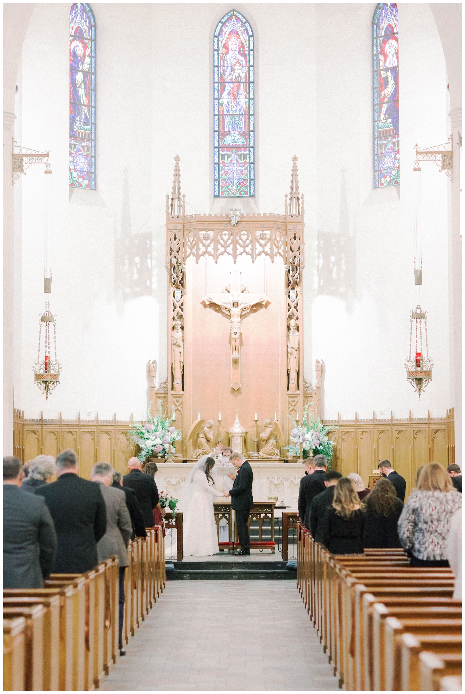 bride and groom praying during Holy Rosary church wedding ceremony