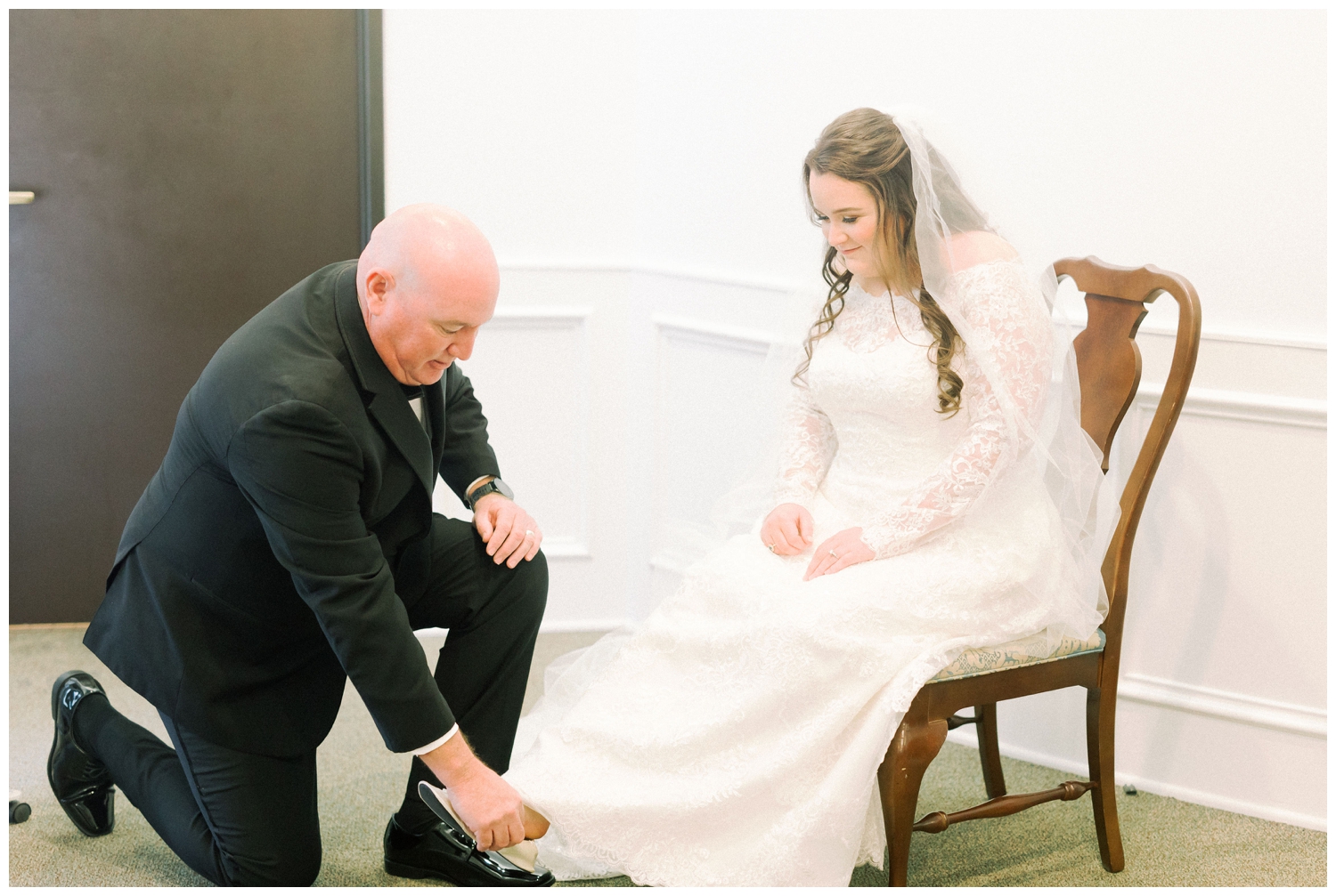 father putting penny inside bride's shoe