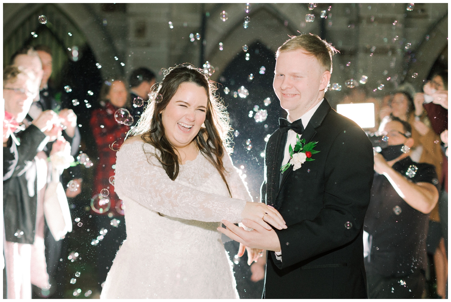 bride and groom laughing during bubble exit from reception at Holy Rosary Church