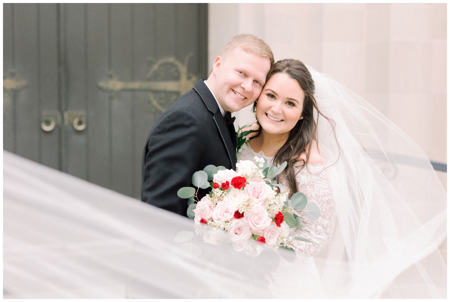 newlywed portrait with veil swoop at Holy Rosary Church