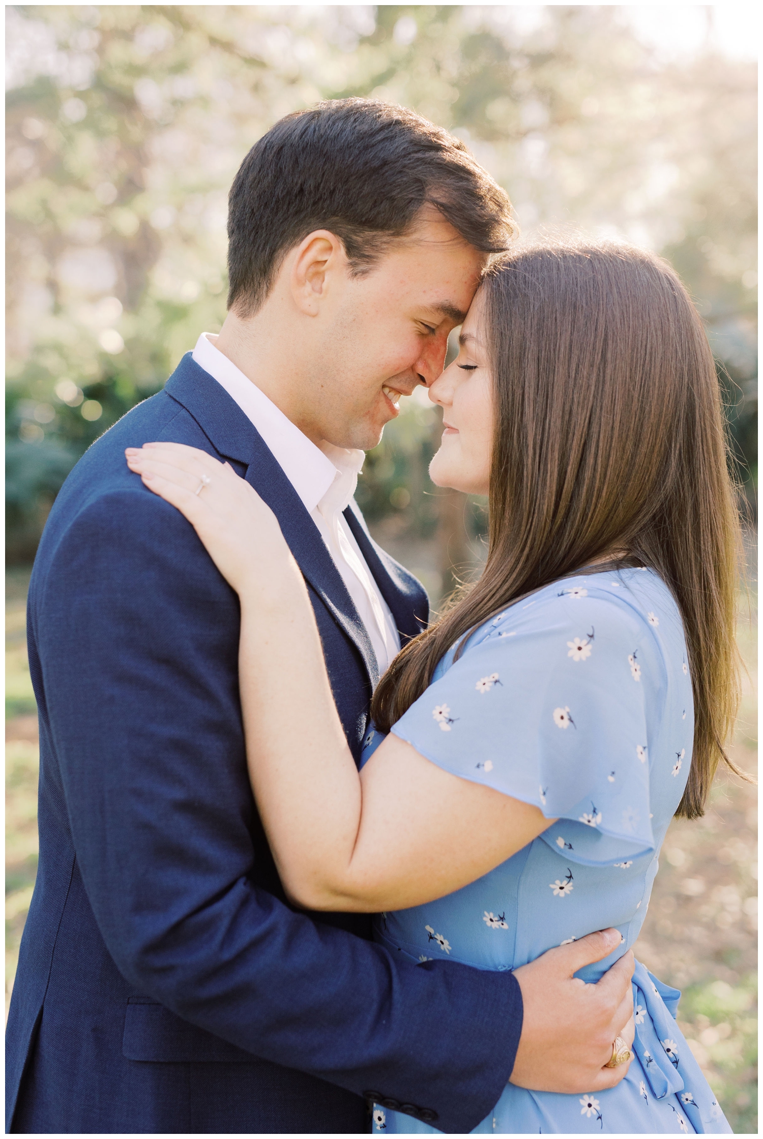 couple in blue suit and blue dress posing for Houston Engagement Photographer in Hermann Park