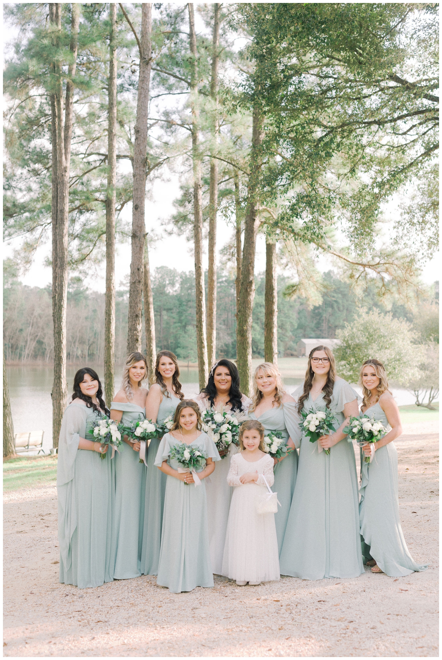 bride with bridesmaid in sage dresses outside Pine Lake Ranch