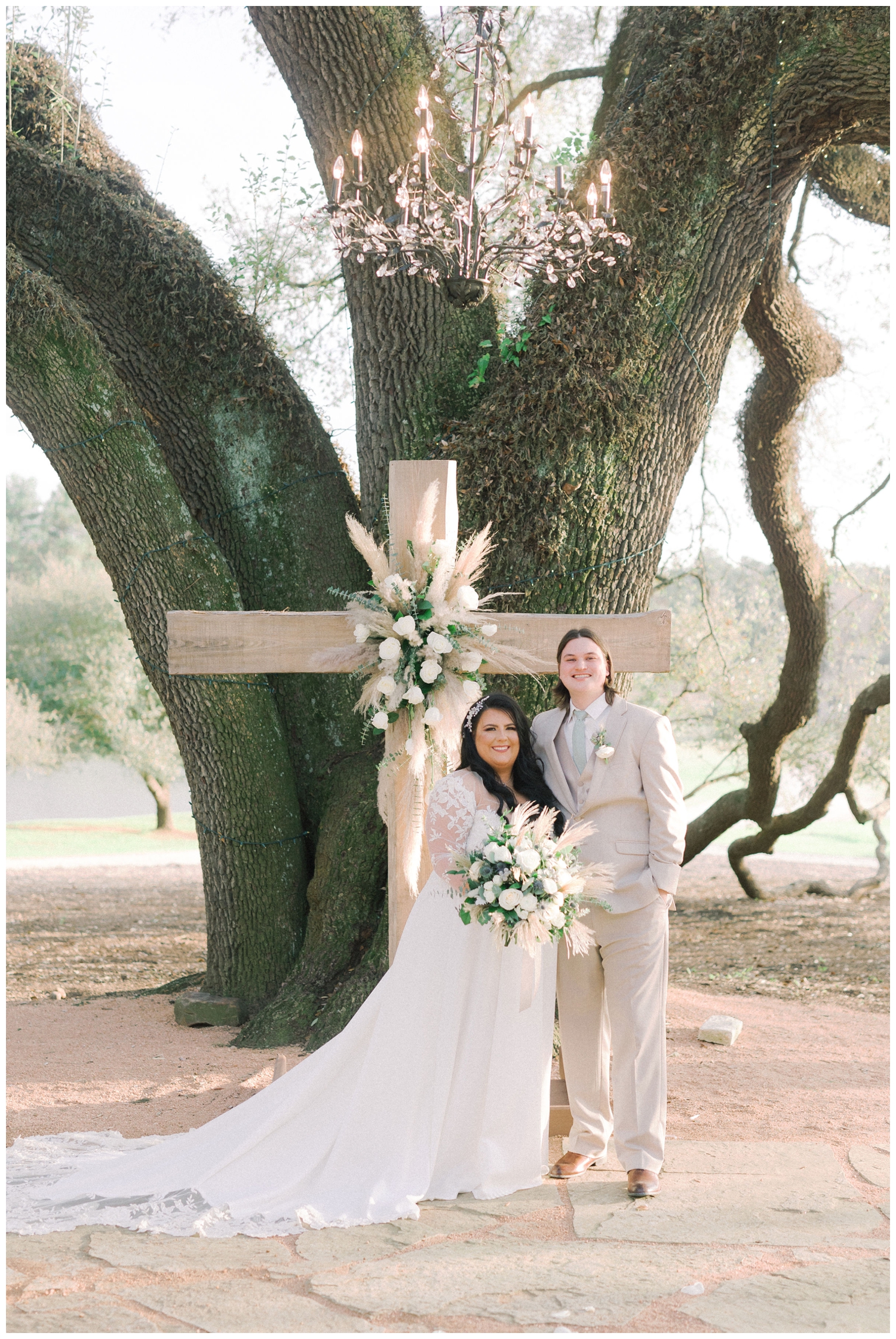 bride and groom portrait by floral cross outdoors