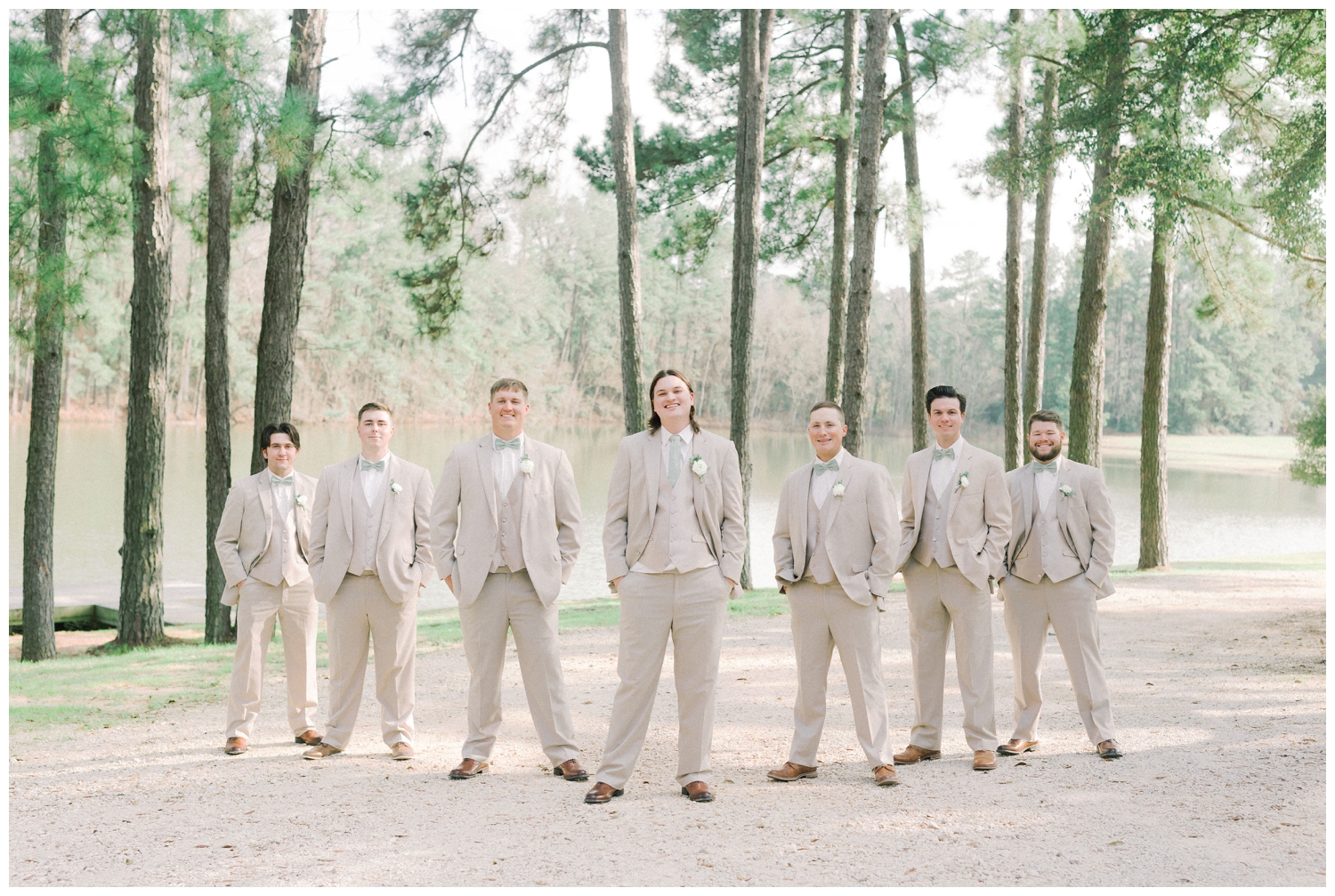 groom and groomsmen posing in tan suits outside Pine Lake Ranch