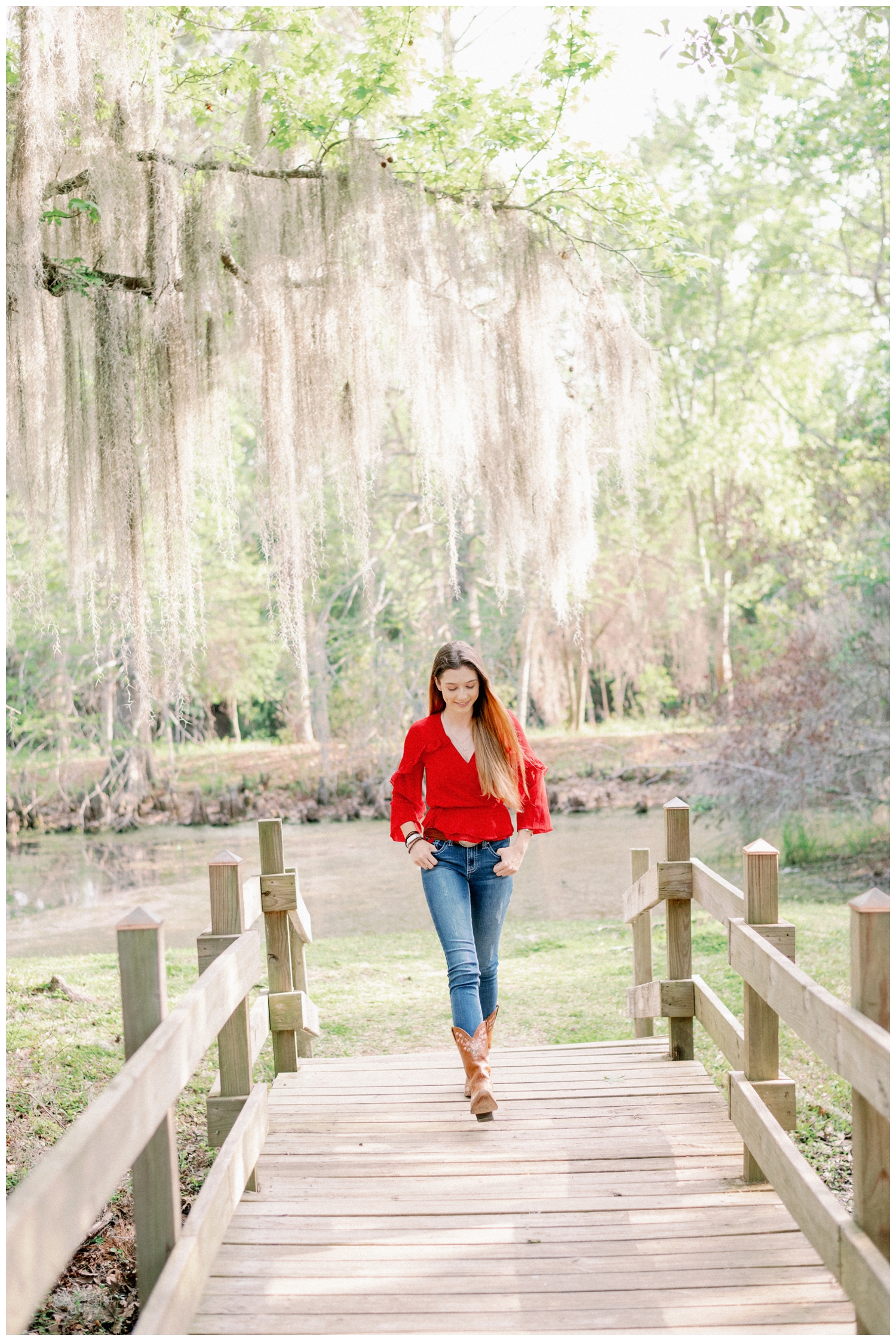 girl walking on a bridge at Cy-Hope under the mossy tree for a Cypress Senior Photographer