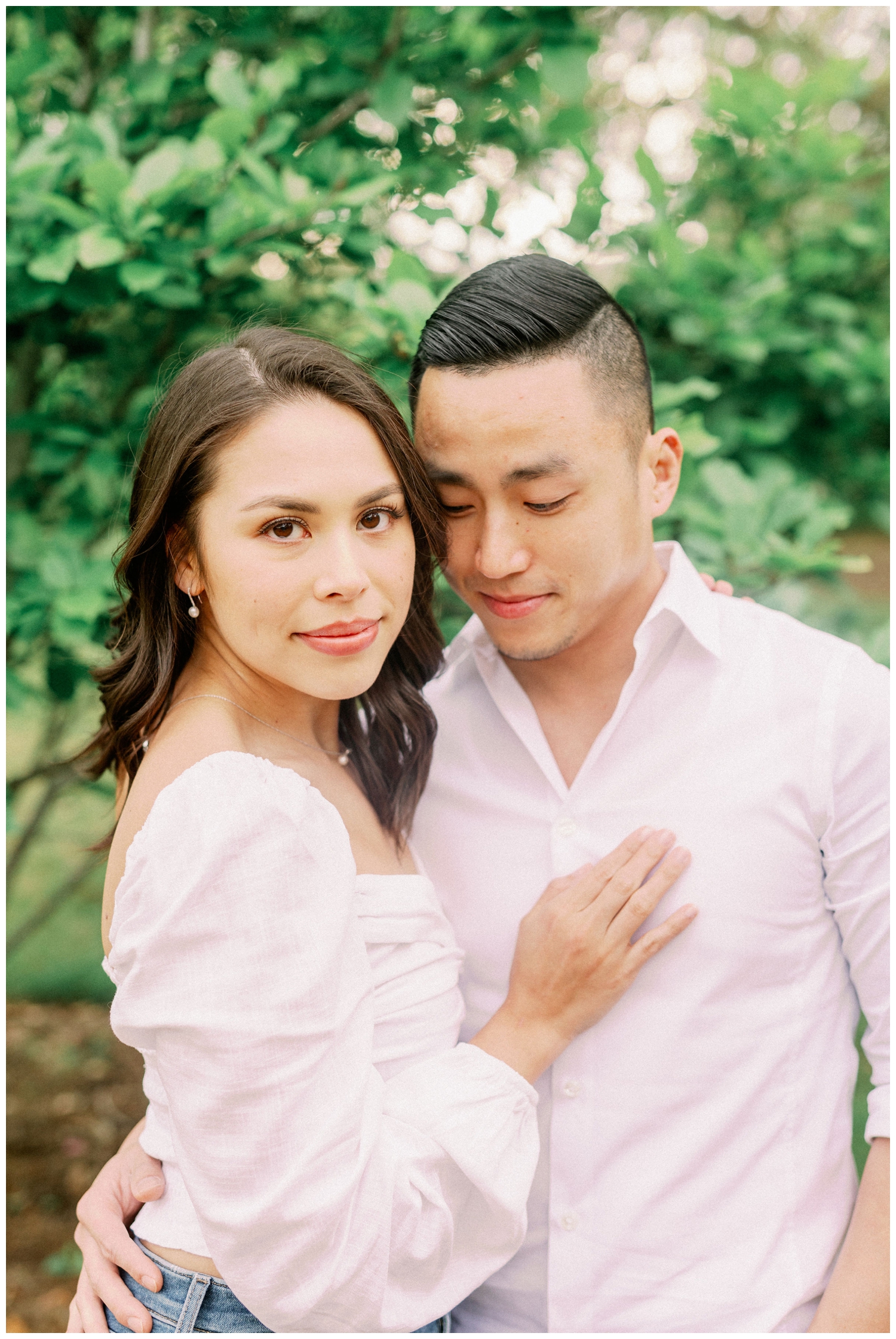 couple posing in white shirts looking at camera