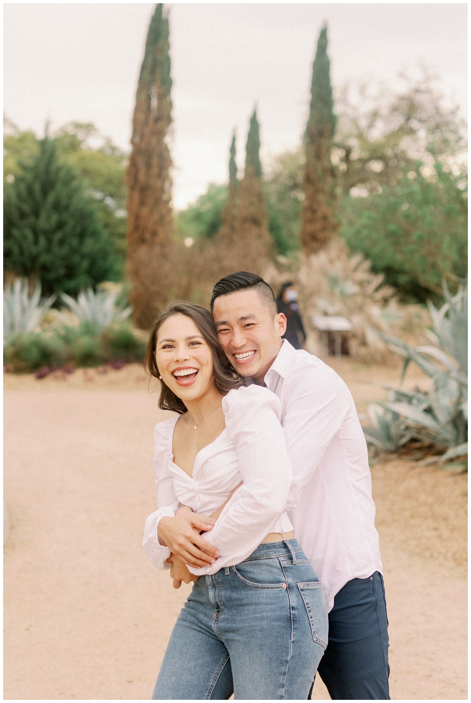 couple hugging and laughing at McGovern Centennial Gardens engagement photos in Houston Texas