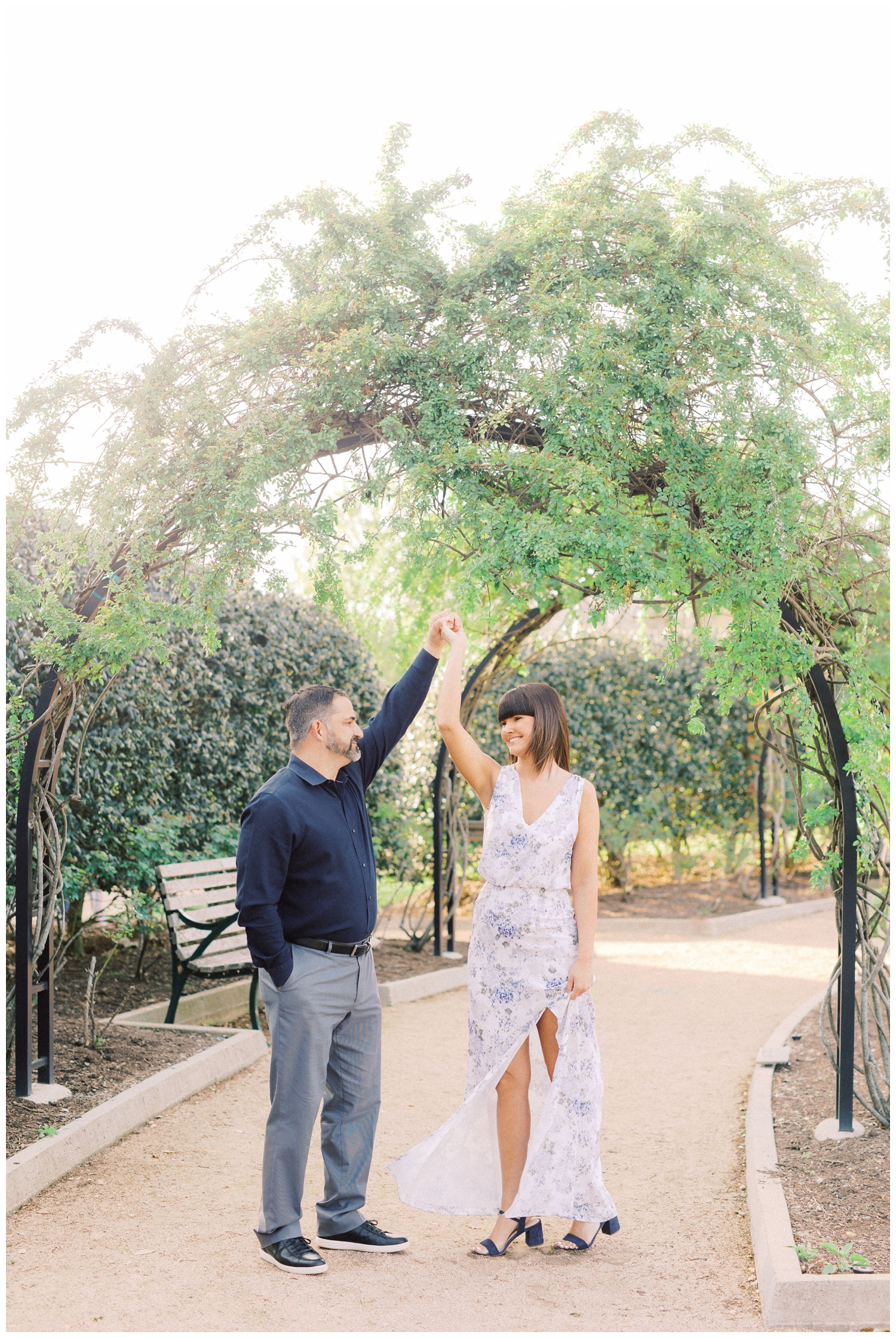 couple dancing under green arches at McGovern Centennial Gardens engagement session