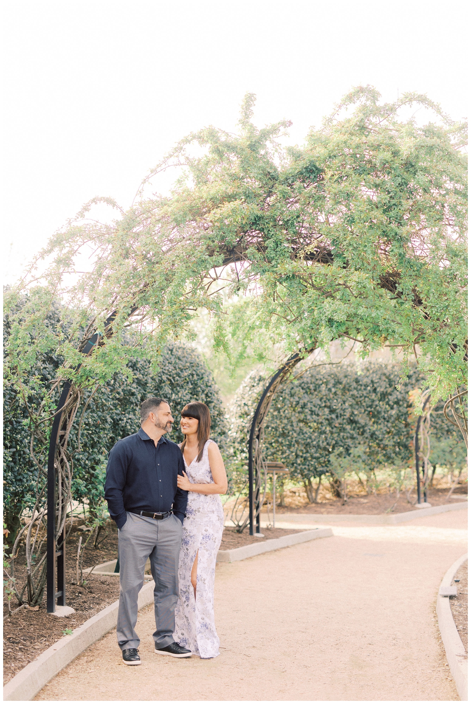 couple posing under archway at McGovern Centennial Gardens in Houston, Texas