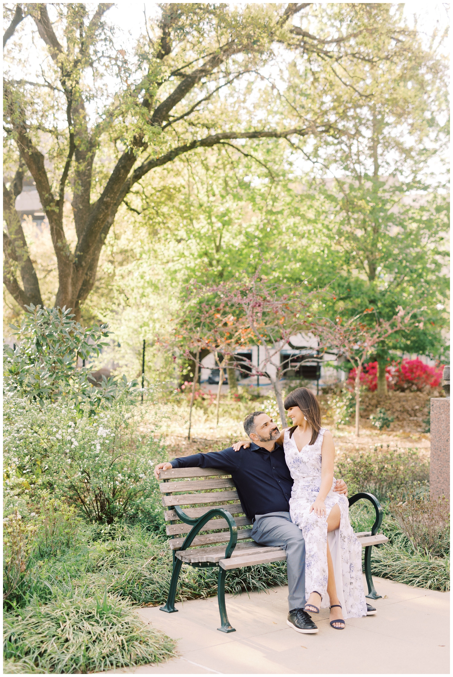 couple sitting on park bench at McGovern Centennial Gardens engagement session