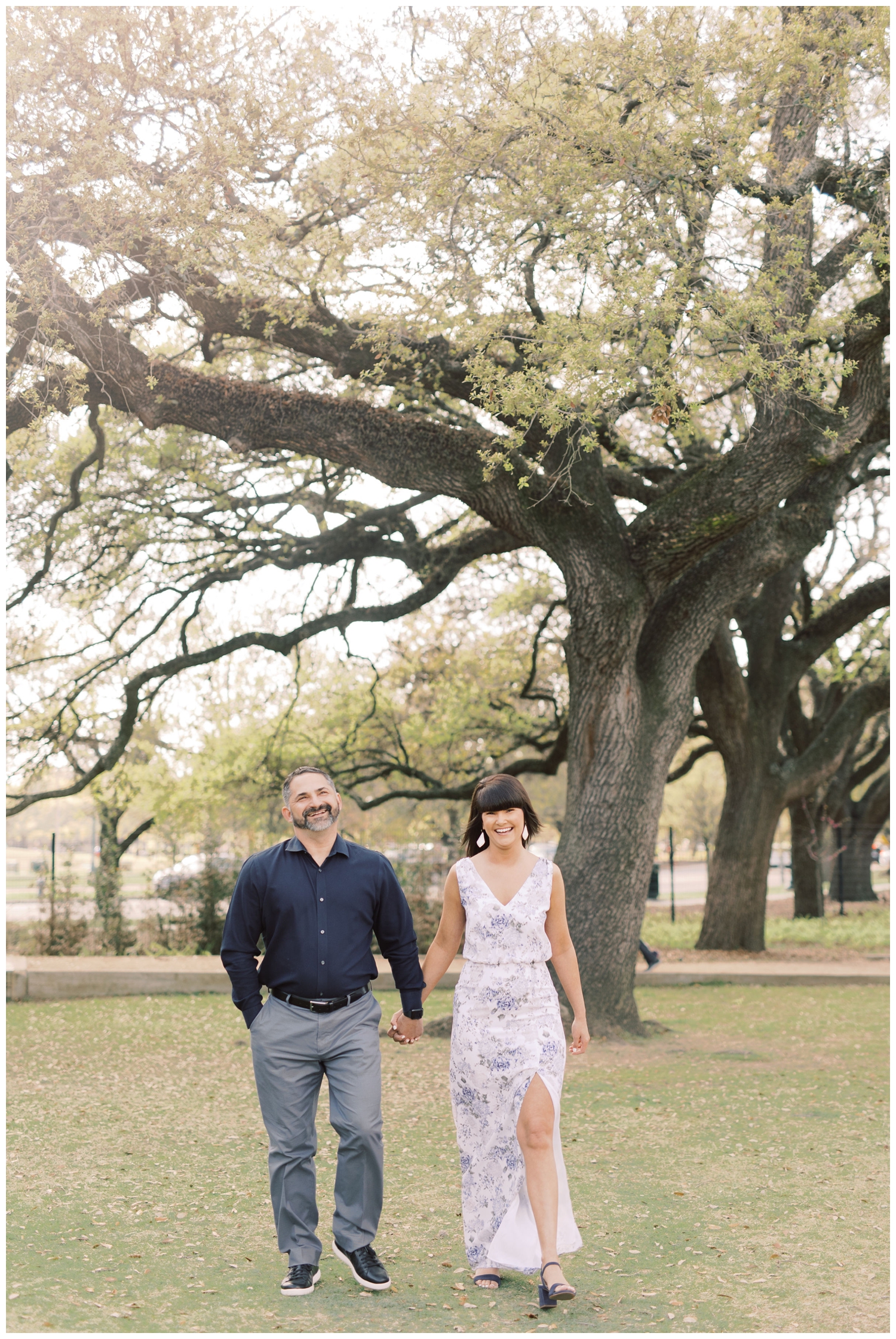 couple walking under oak tree at McGovern Centennial Gardens engagement session