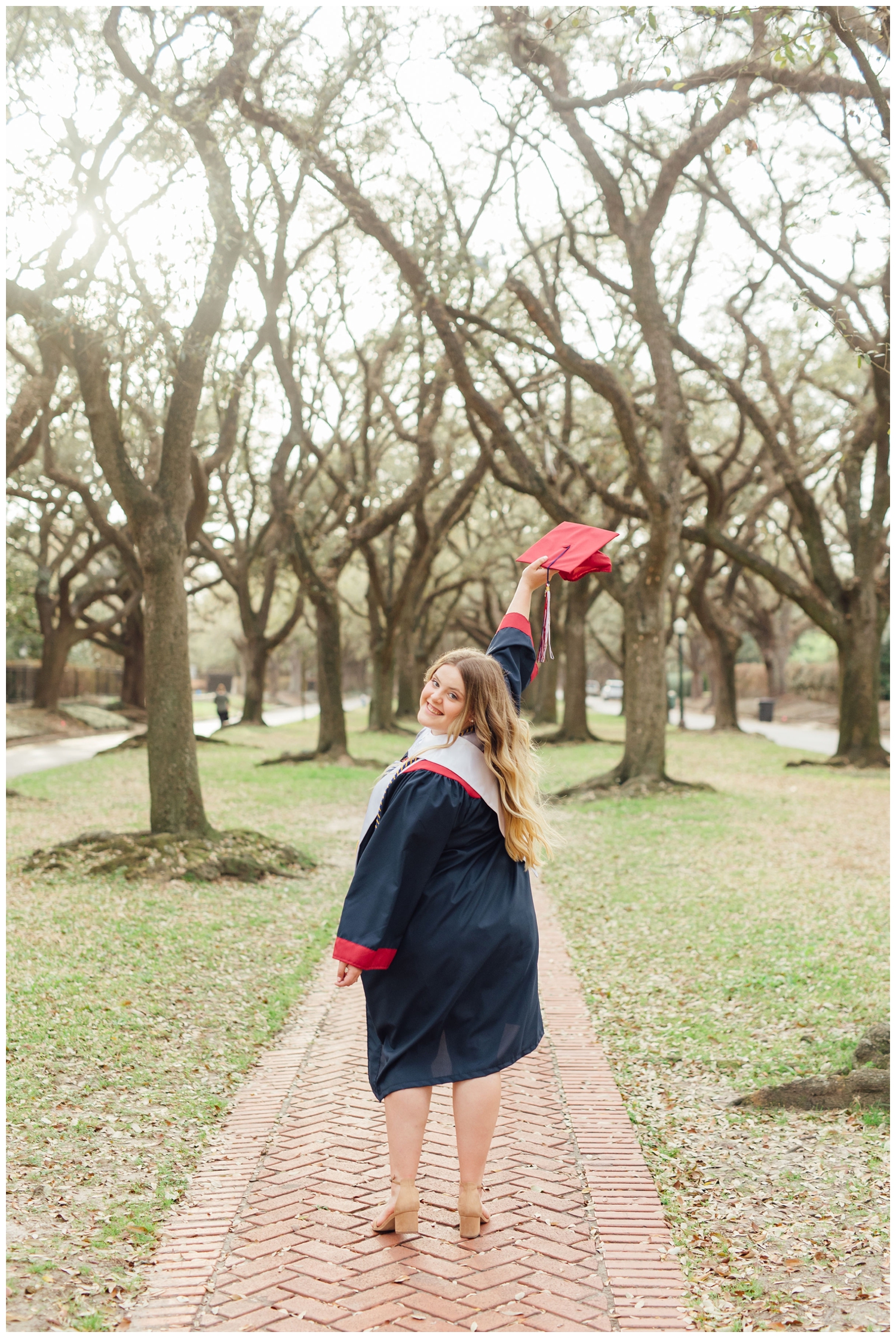 high school senior girl waving graduation cap in Houston Texas