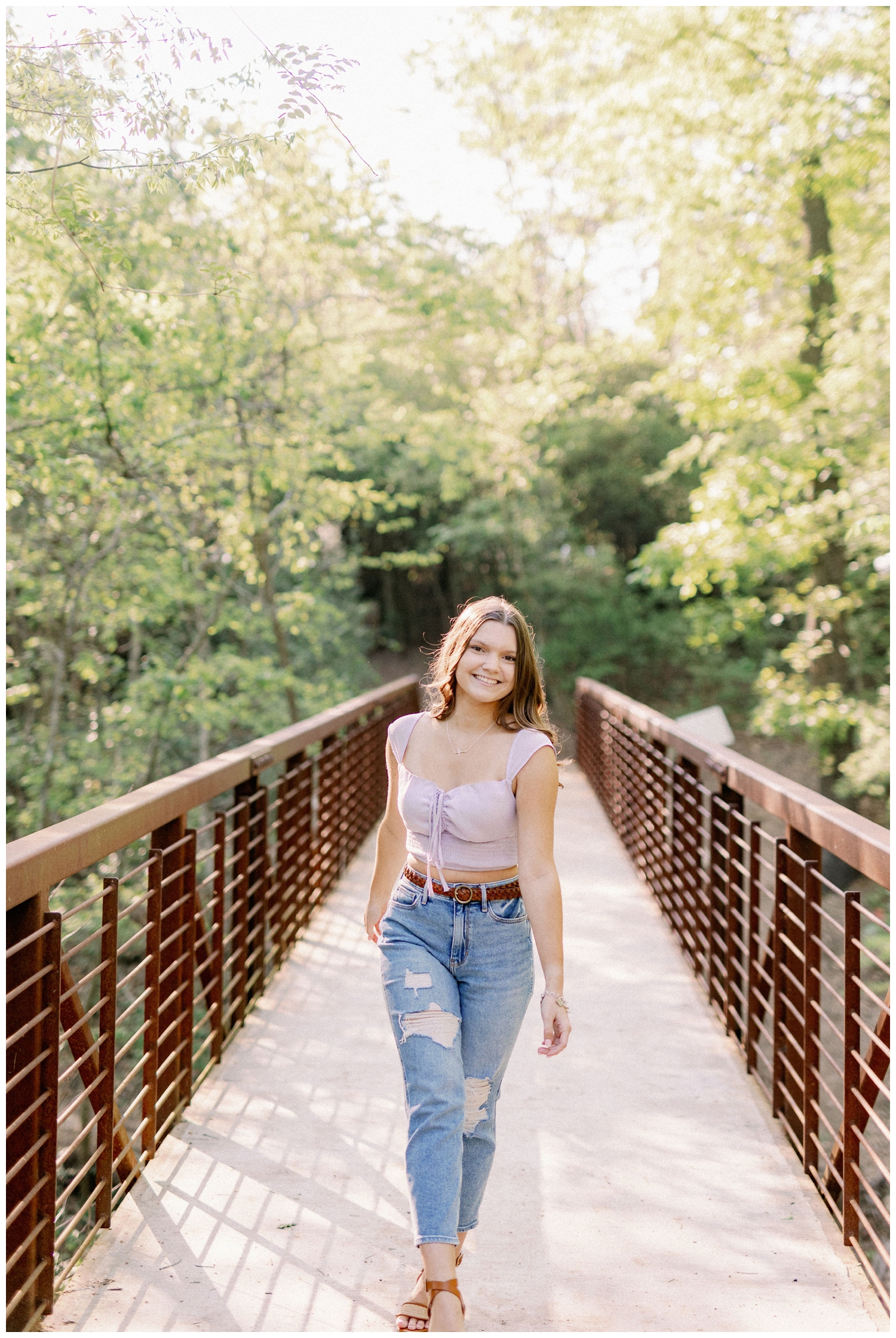 girl walking on a bridge girl standing in a field smiling senior photos Houston Arboretum