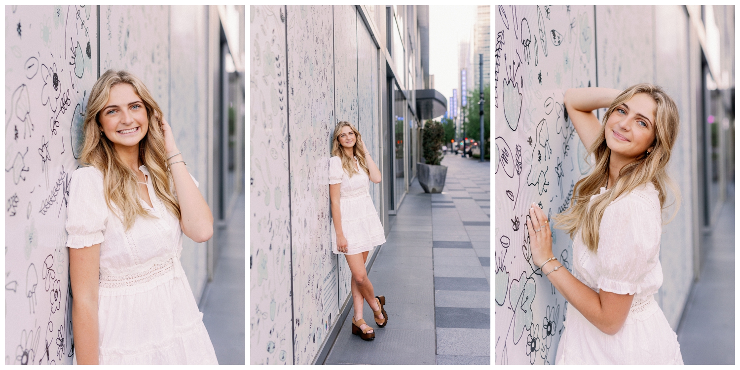 high school senior girl leaning against graffiti wall downtown Houston