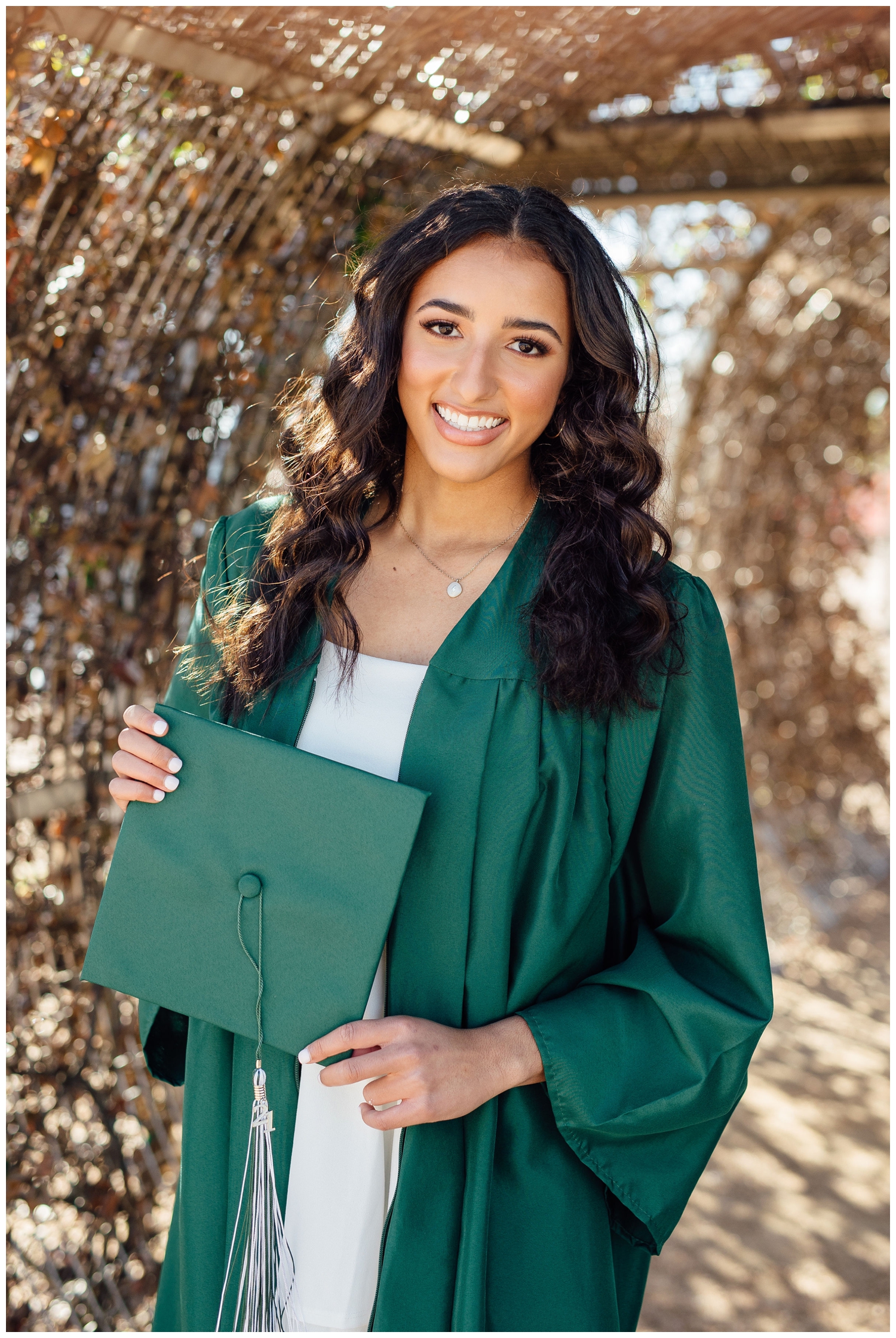 girl in cap and gown smiling