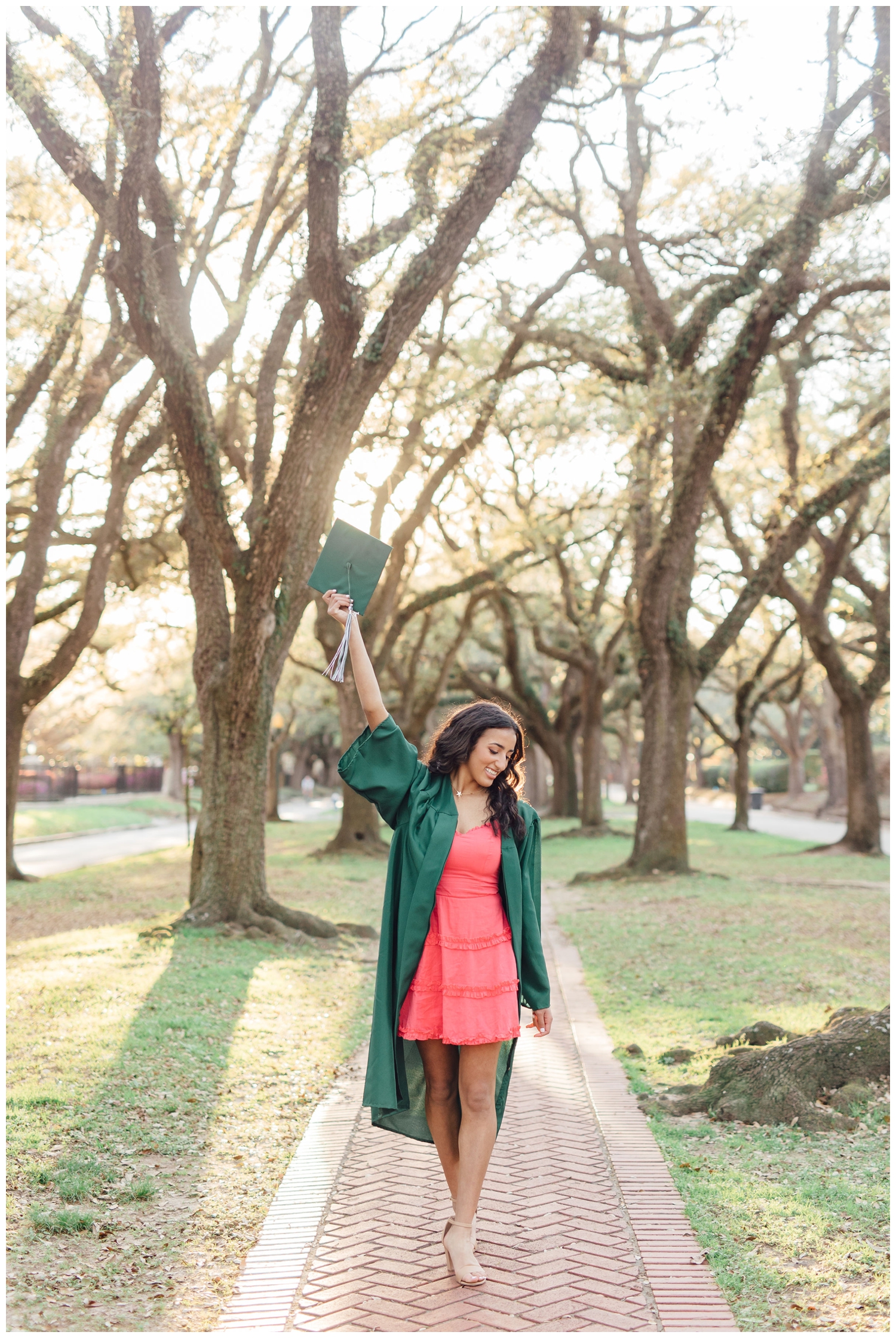 girl walking and waving grad cap during vibrant Houston senior portraits in Houston, Texas