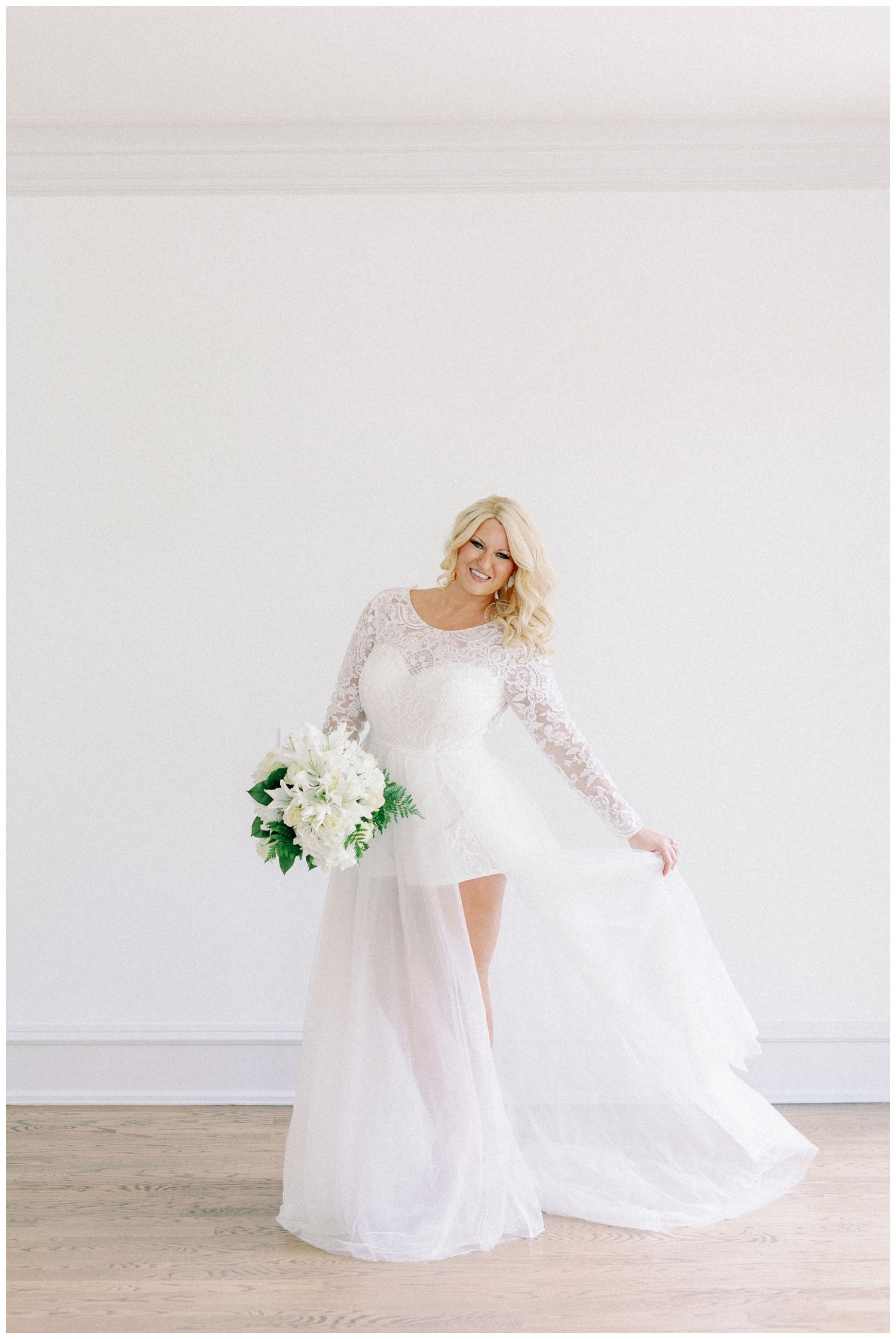 bride twirling her dress holding white bouquet