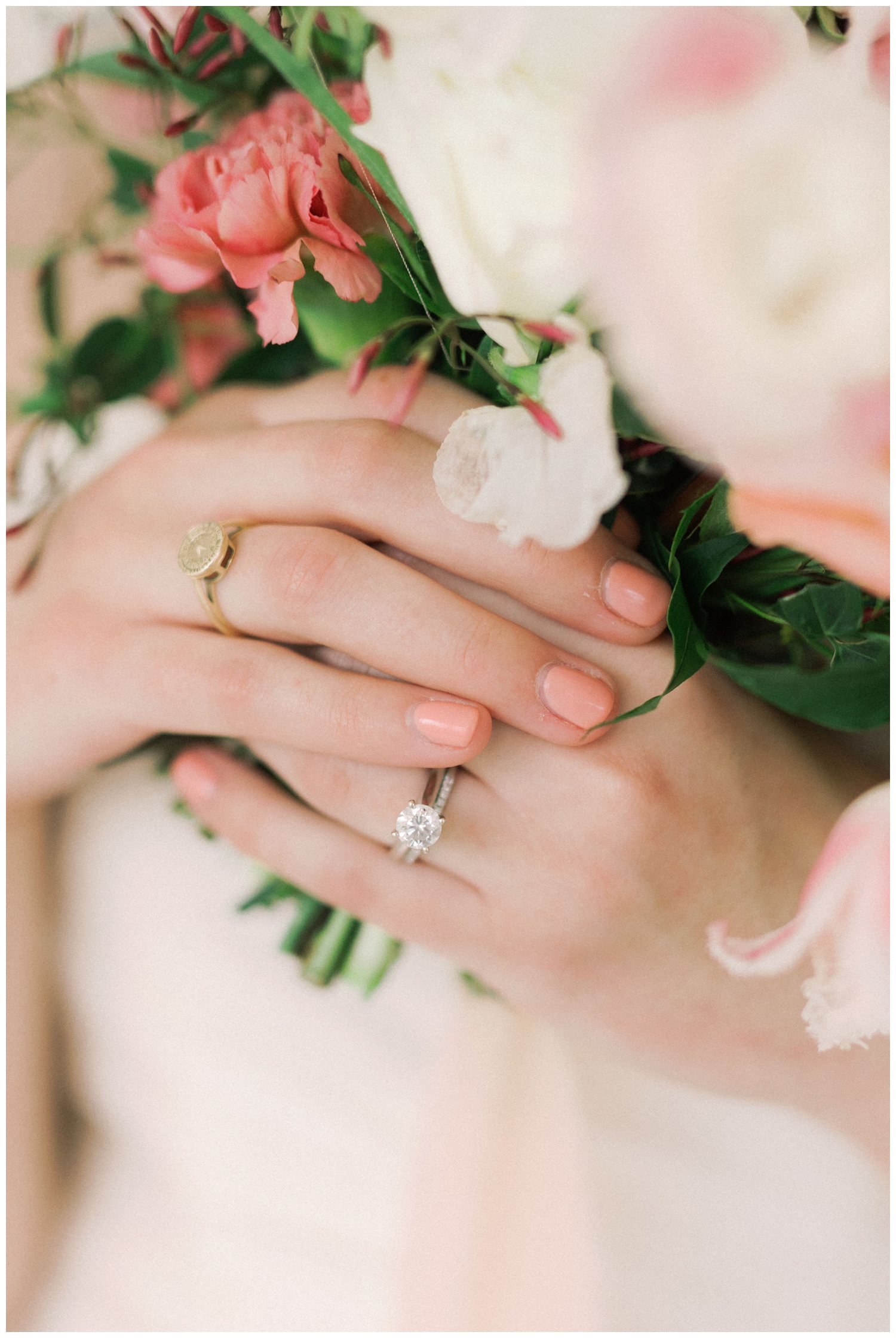 close up of brides hands with wedding ring holding bouquet