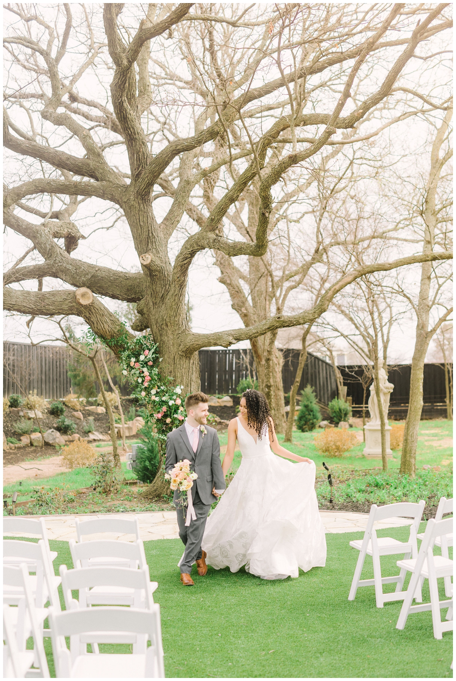 bride and groom skipping down the aisle at Brighton Abbey wedding venue outside in the garden