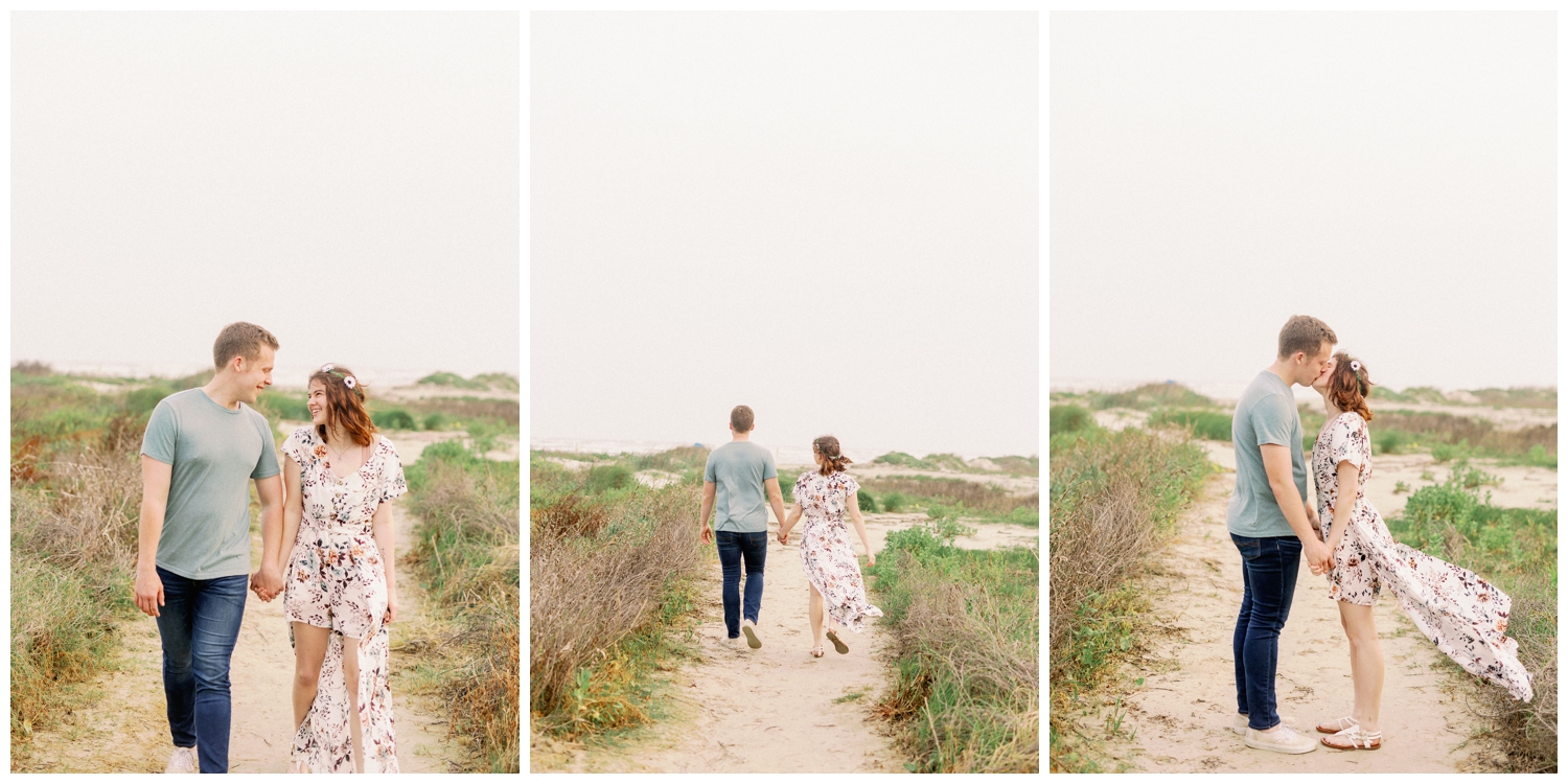 couple walking in the sand on Galveston Beach