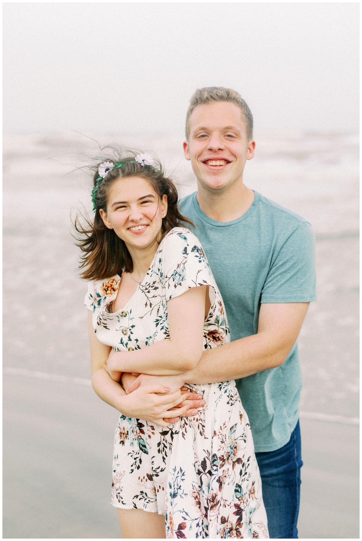 close up of engaged couple standing in sand on Galveston Beach